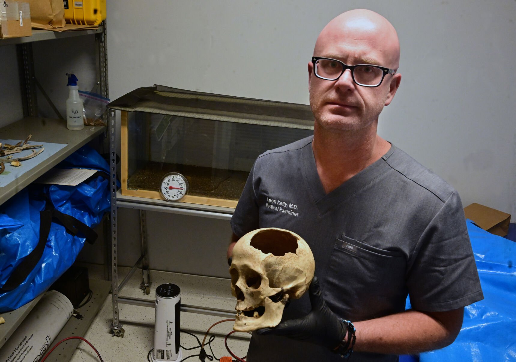 Dr. Leon Kelly in a storage room at the El Paso County Sheriff’s Office that holds a donated skull and a terrarium full of flesh-eating beetles, among other items.