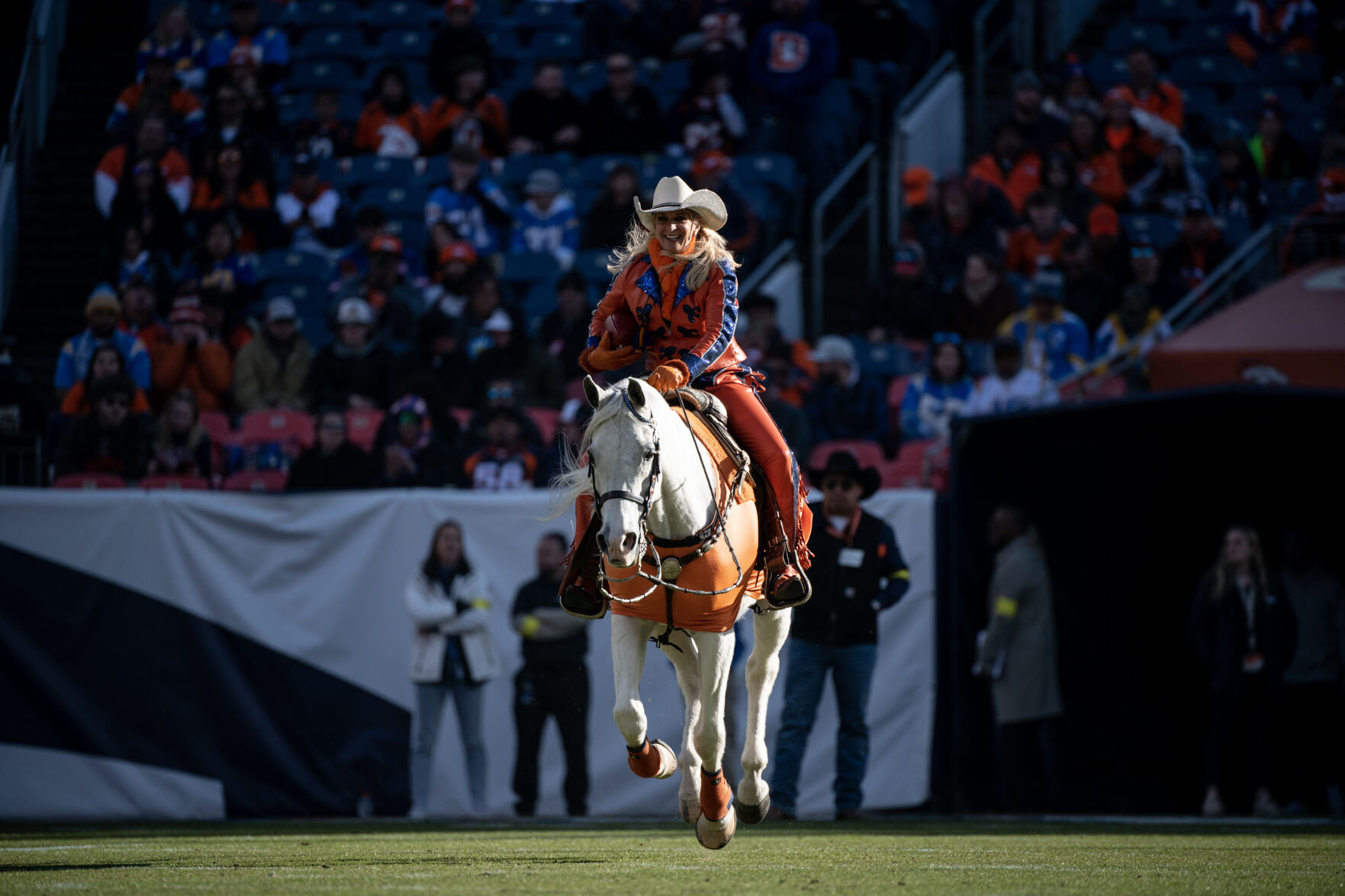 Thunder and his rider Ann Judge deliver the game ball at the start of the last regular season game Sunday, Jan. 8, 2023 at Empower Field at Mile High in Denver. (Parker Seibold, The Gazette) (Parker Seibold)