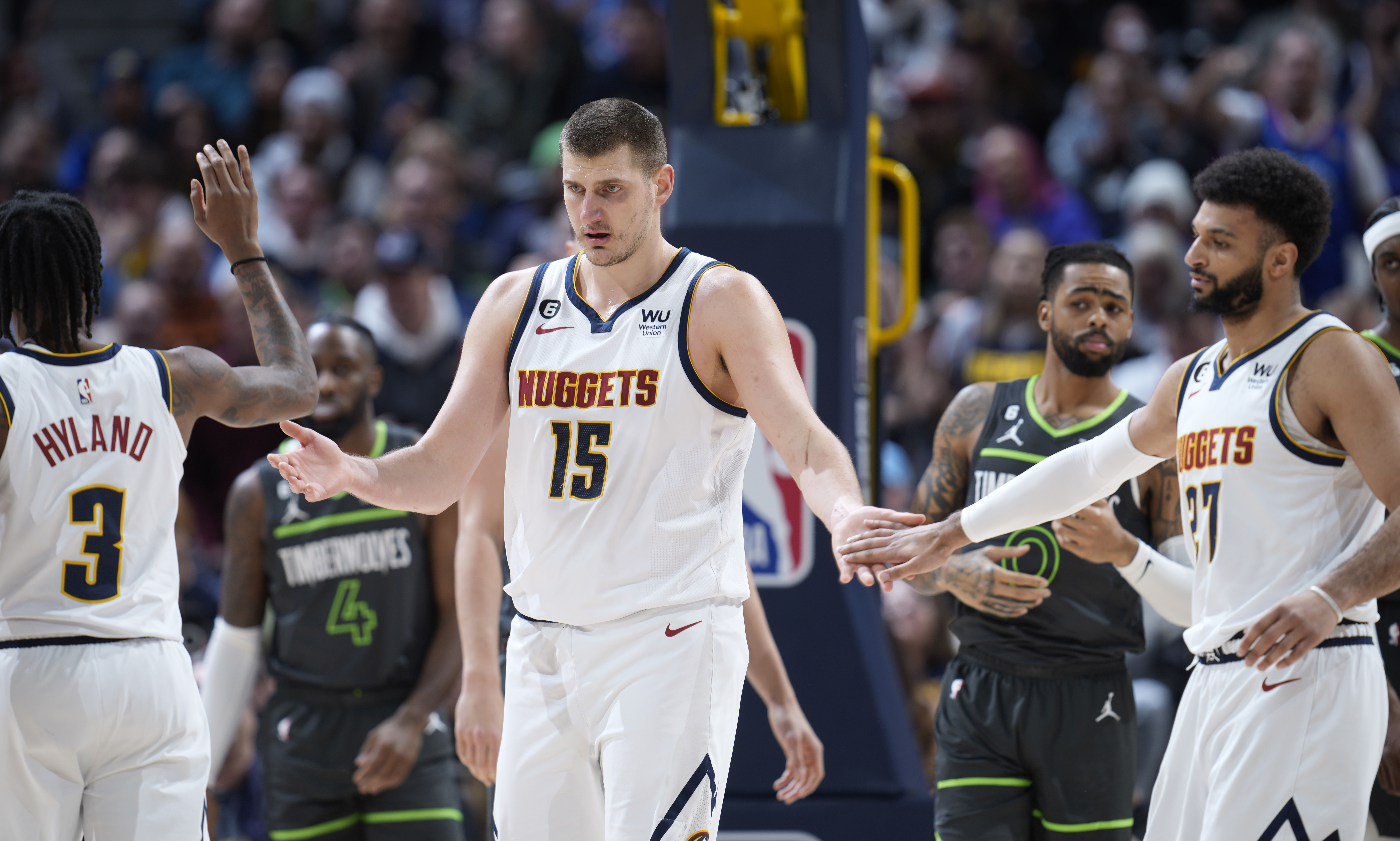 Denver Nuggets center Nikola Jokic (15) is congratulatged after making a basket and drawing a foul by guards Bones Hyland, left, and Jamal Murray in the first half of an NBA basketball game against the Minnesota Timberwolves Wednesday, Jan. 18, 2023, in Denver. (AP Photo/David Zalubowski) (David Zalubowski)