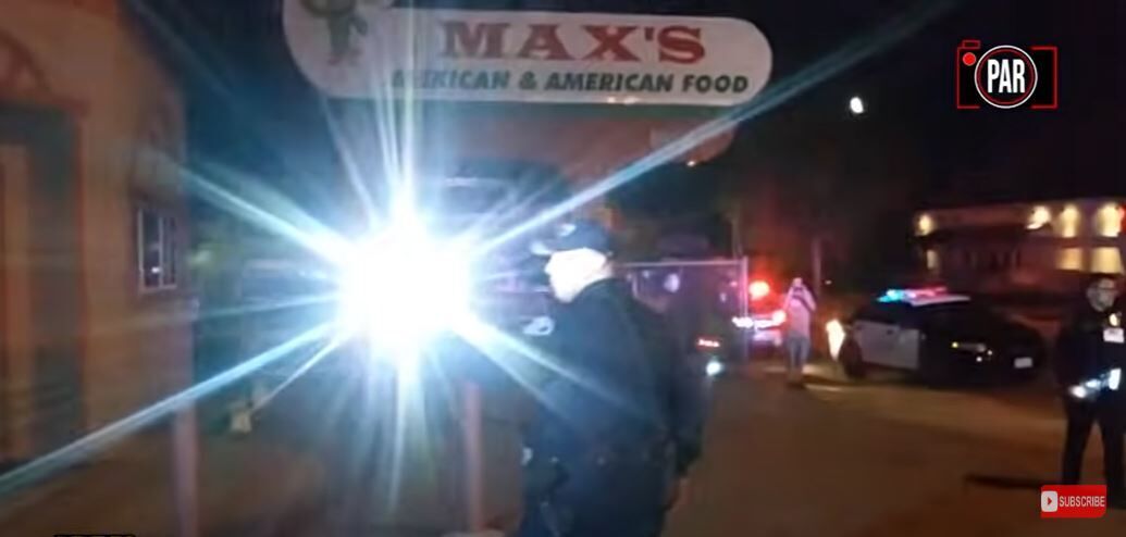 Lakewood police Agent Ahmed Yehia shines a flashlight into the camera of Abade Irizarry in video captured on the morning of May 26, 2019. Screenshot courtesy of The Real News Network.