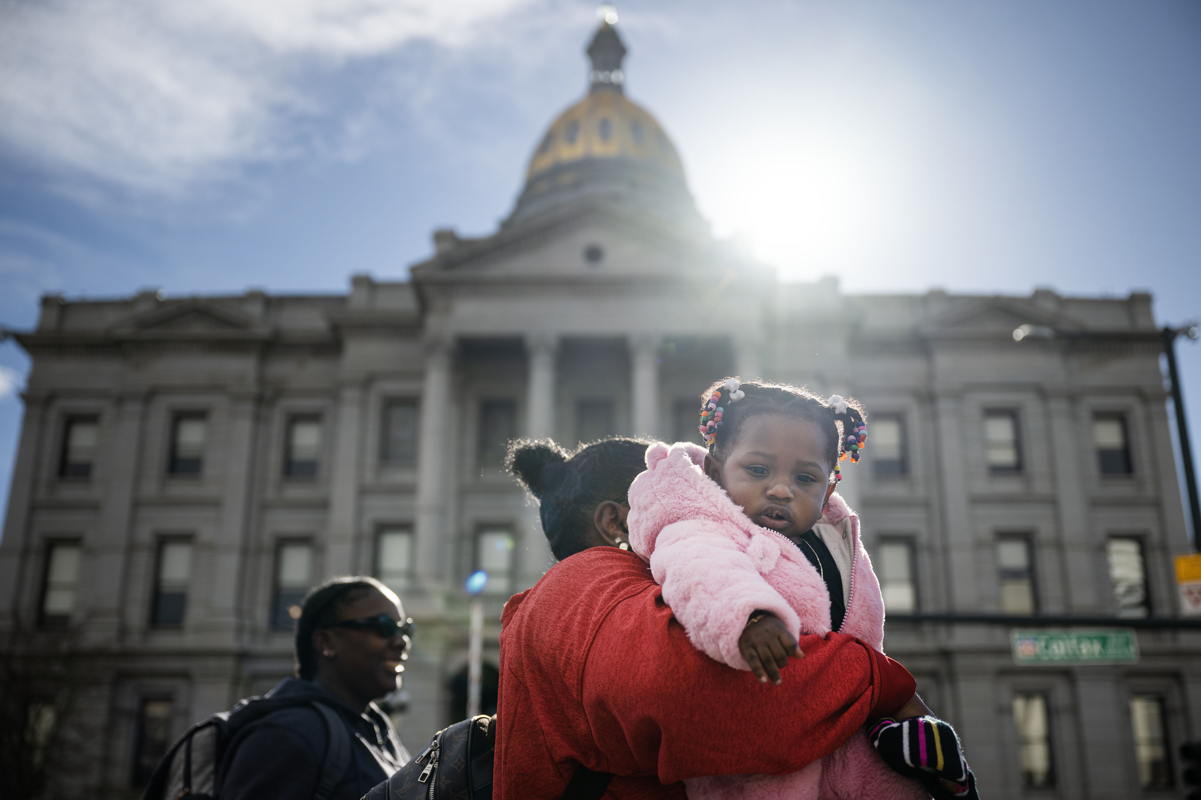 Stephanie Wesley-Clifton carries her granddaughter Shi’laya past the State Capitol Building during Denver's annual Martin Luther King Jr. Day marade on Monday, Jan. 16, 2023, in Denver, Colo.(Timothy Hurst/The Denver Gazette) (TimHursttim.hurst@gazette.comhttps://secure.gravatar.com/avatar/aca82bd62b4ee425c598527cd6faa1b1?d=mm&r=g)