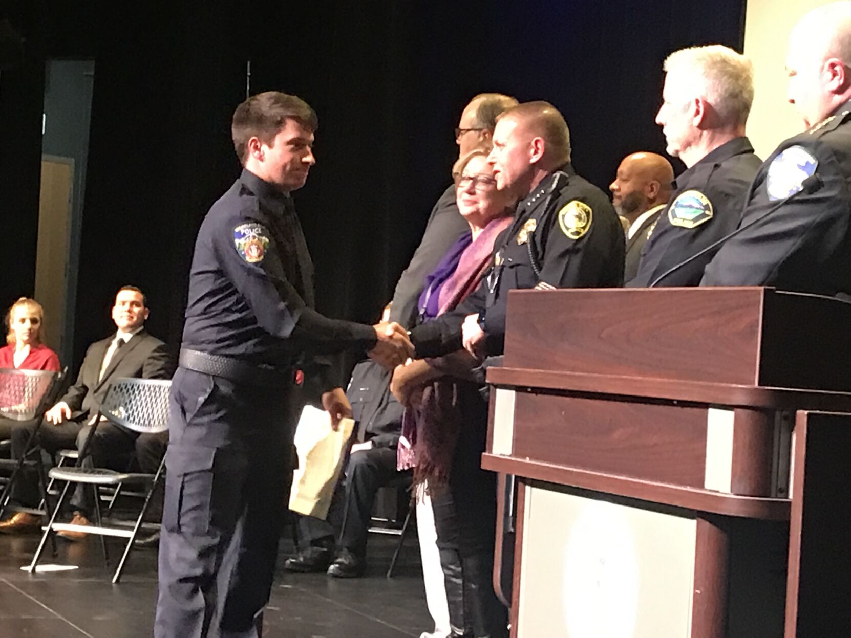 Sam Dunbar, left, shakes hands with Cañon City Police Chief John Schick after receiving his completion certificate from the Pikes Peak Regional Law Enforcement Academy. (O'Dell Isaac, The Gazette)