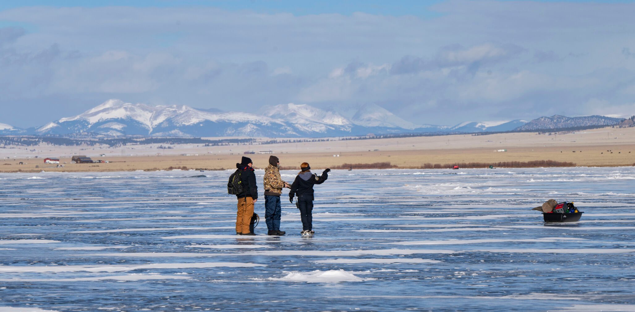 Lewis talks to anglers about the ice fishing conditions Jan. 6 while patrolling. (Christian Murdock, The Gazette)