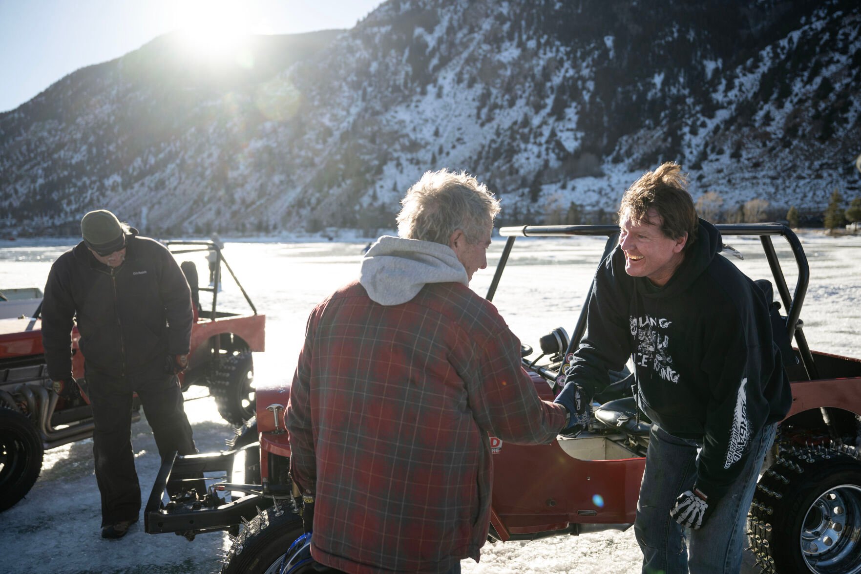 Men’s Competition Cheaters race winner Lee Bashline, left, and second place driver Mark Lannerd shakes hands after a close final race during the first day of the Our Gang 4 Wheelers ice racing club’s 2023 racing season on Saturday, Jan. 7, 2023, in Georgetown, Colo. The Cheater division is named for the tires used, which have 1 1/2 inch sharpened bolts protruding from them. (Timothy Hurst/The Denver Gazette) (TIMOTHY HURST/DENVER GAZETTE)