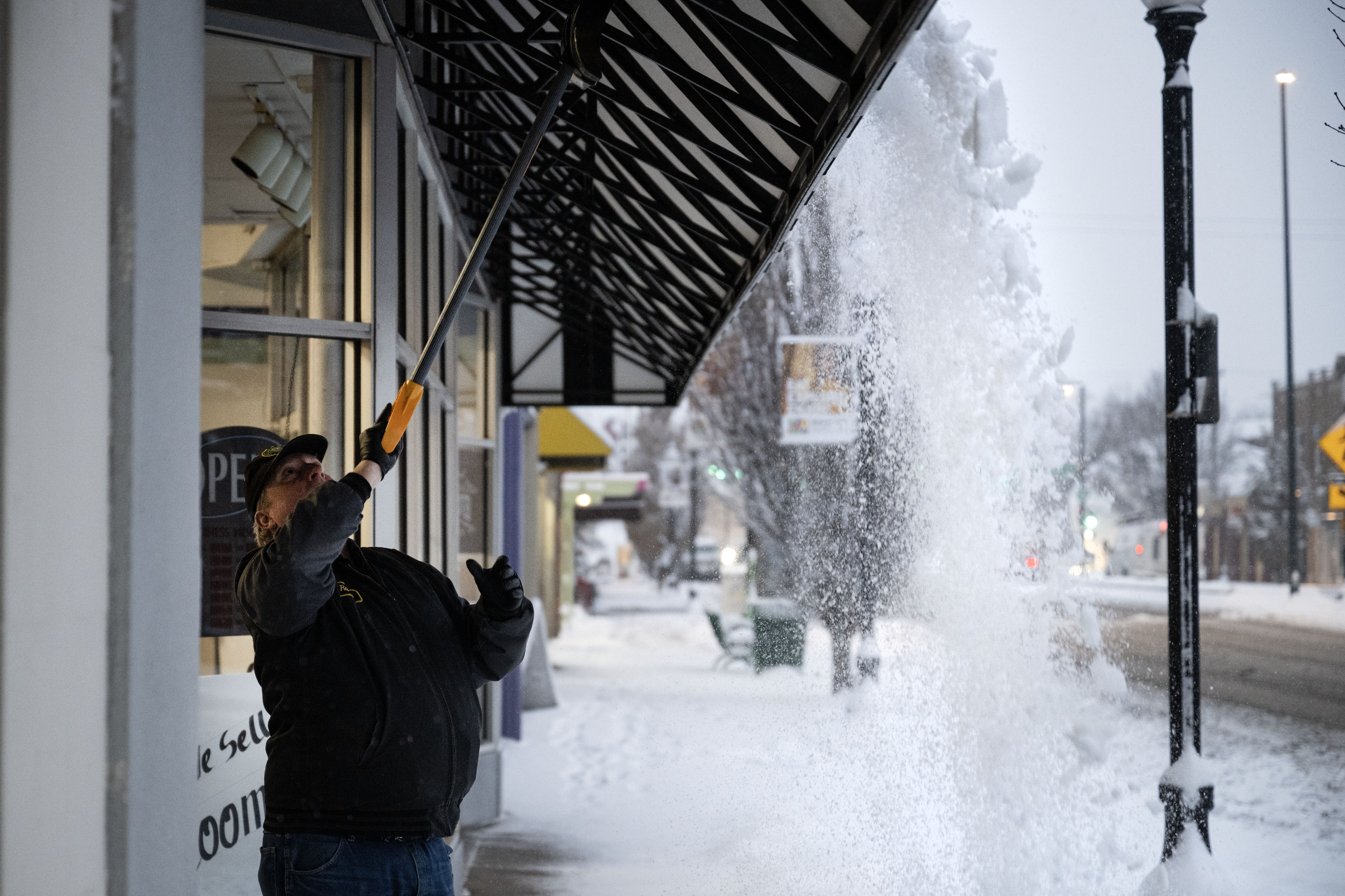 Anderson's Vacuum lead technician Randy Ferguson knocks the snow off the awning over the storefront before shoveling the sidewalk after an overnight snowstorm on Wednesday, Jan. 18, 2023, in Englewood, Colo.(Timothy Hurst/The Denver Gazette) (TimHursttim.hurst@gazette.comhttps://secure.gravatar.com/avatar/aca82bd62b4ee425c598527cd6faa1b1?d=mm&r=g)