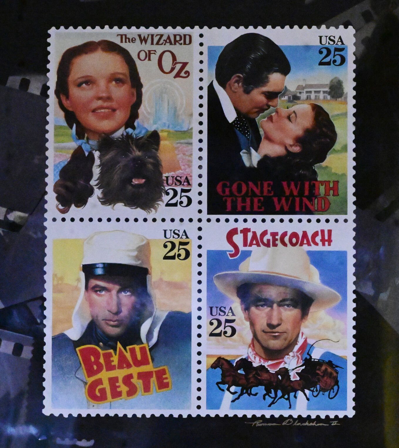 Thomas Blackshear III has painted multiple vintage movie posters that have been used on postage stamps. A display hangs on his wall in his studio.