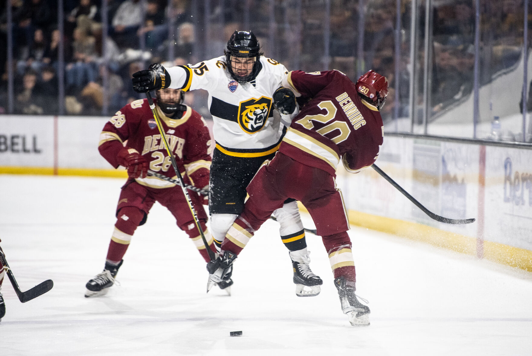 Denver defenseman Mike Benning (20) checks Colorado College forward Matthew Gleason (15) in the third period of a hockey game on Saturday, Feb. 4, 2023, at Ed Robson Arena in Colorado Springs, Colo. (Parker Seibold, The Gazette) (Parker Seibold)