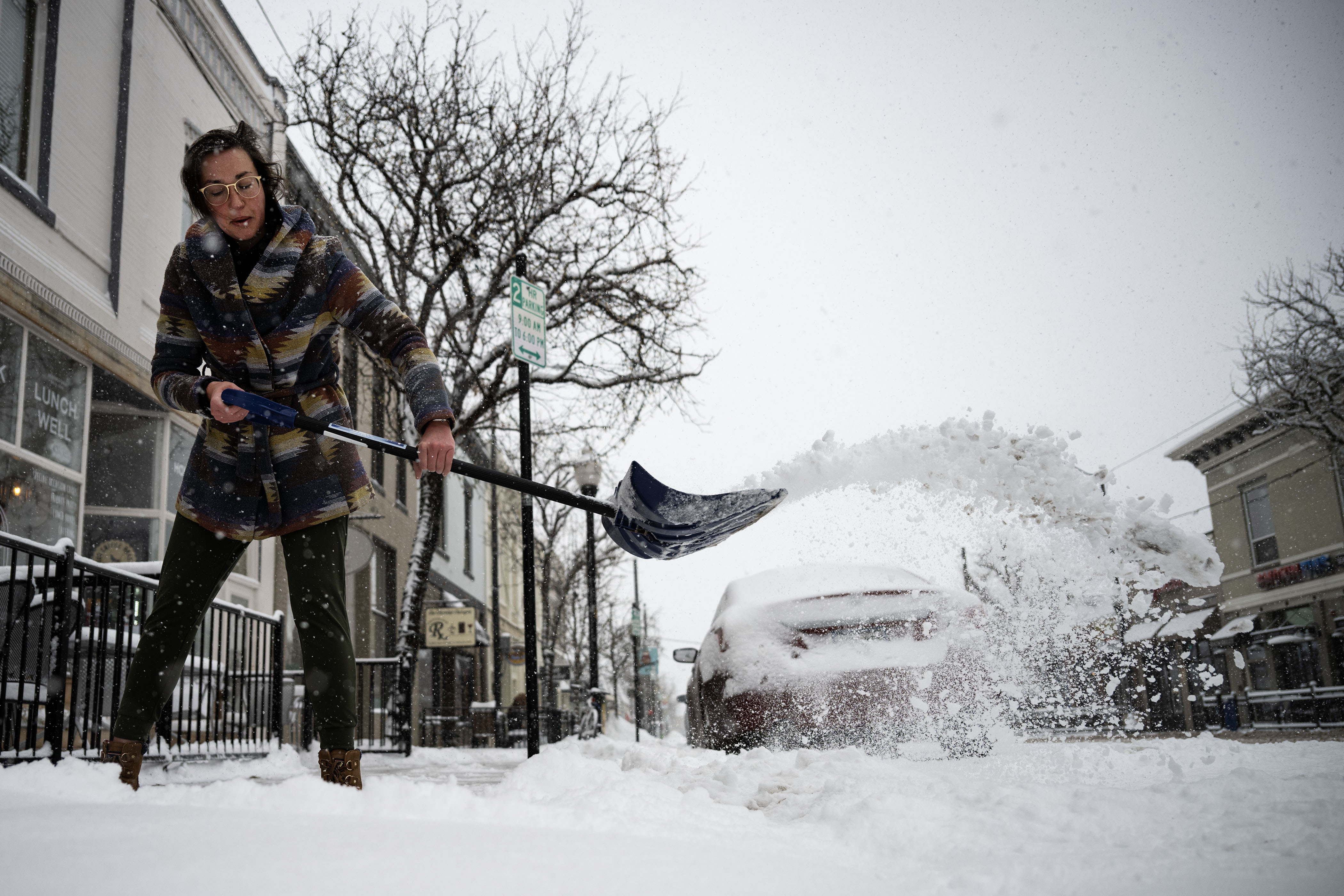 FILE PHOTO: Baker Kenzie Lyons shovels off the sidewalk in front of Born2Bake after shoveling a path around the block on Wednesday, Feb. 15, 2023, in downtown Littleton.(Timothy Hurst/The Denver Gazette) (Timothy Hurst/Denver Gazette)