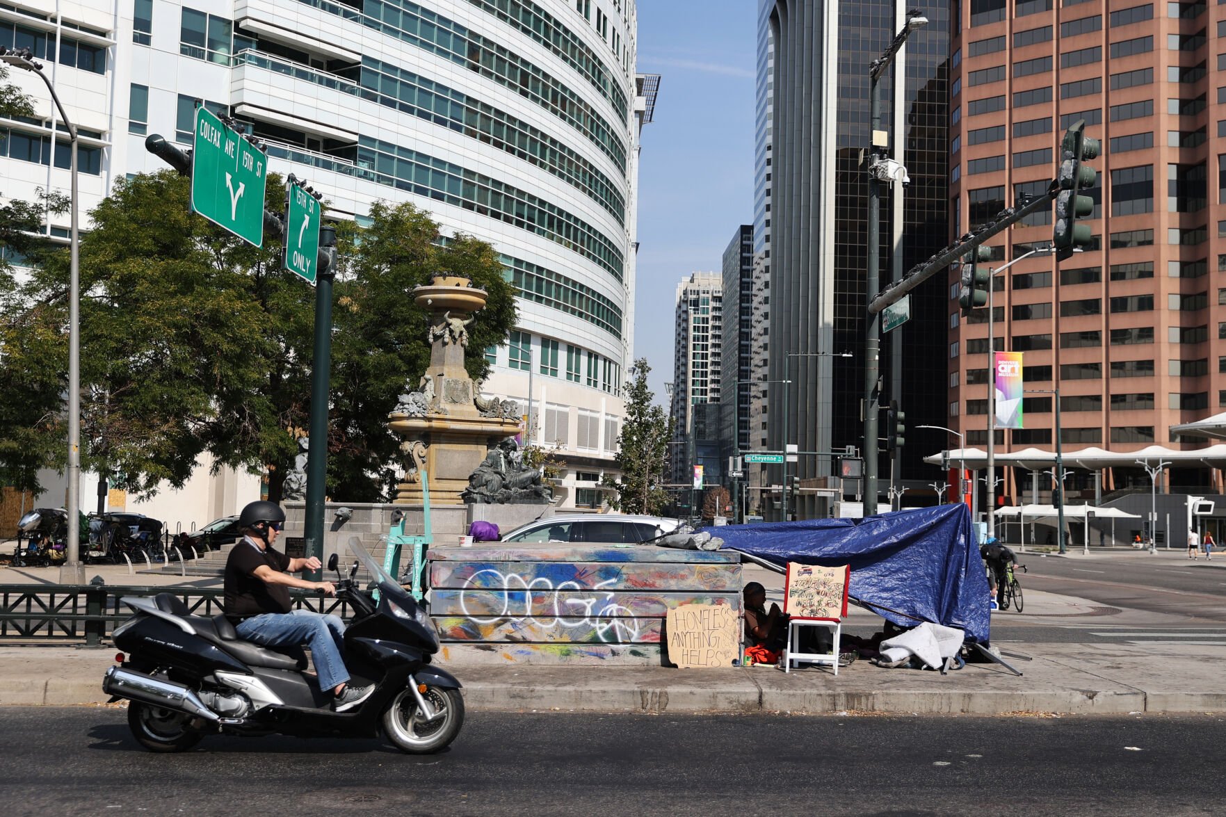 FILE PHOTO: A homeless shelter made up of tarps, chairs and signs sits in the median of Colfax Avenue in downtown Denver. (DENVER GAZETTE)