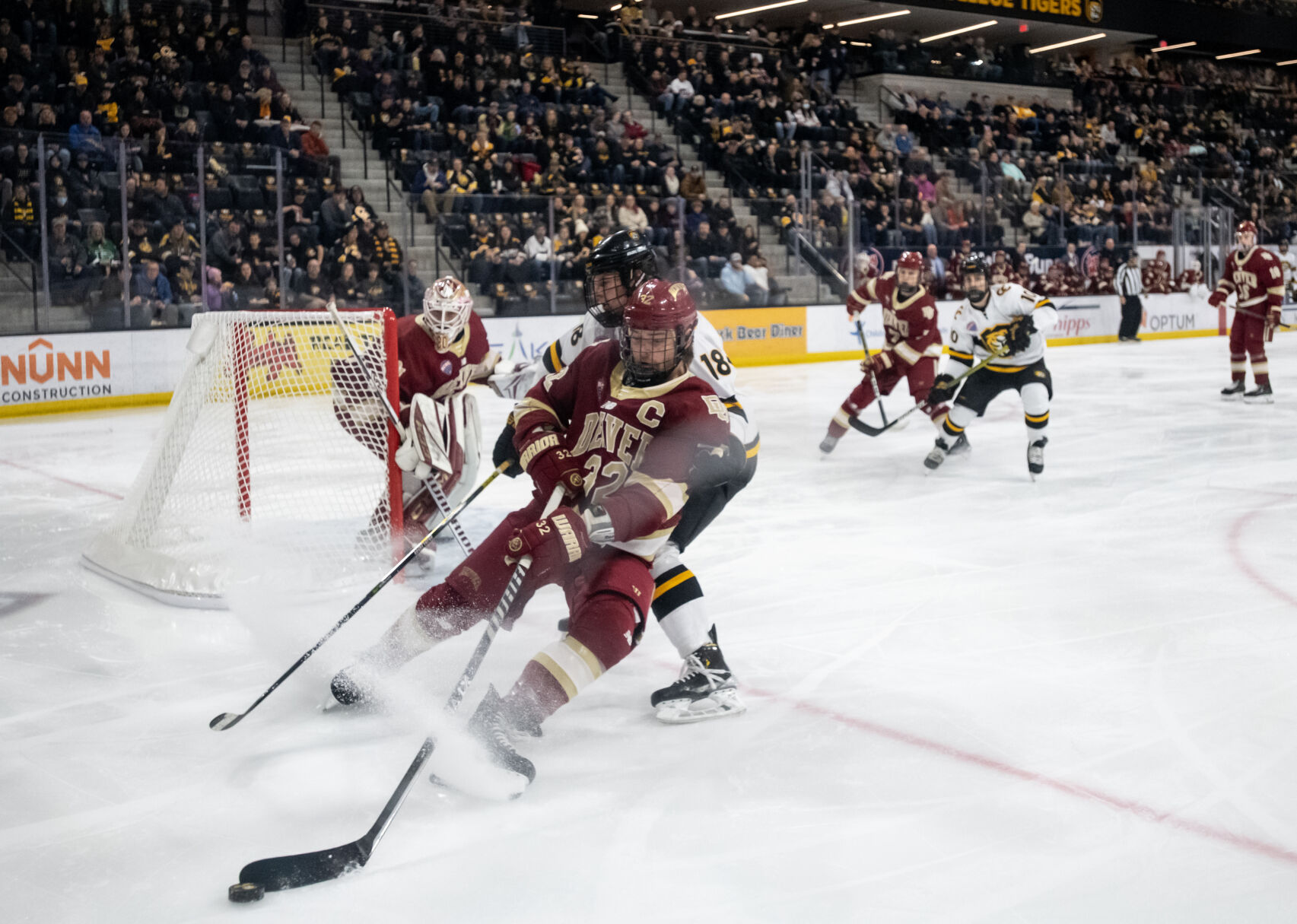 Denver defenseman Justin Lee (32) defends Colorado College defenseman Connor Mayer (18) near DU’s goal in the first period of a hockey game on Saturday, Feb. 4, 2023, at Ed Robson Arena in Colorado Springs, Colo. (Parker Seibold, The Gazette) (Parker Seibold)