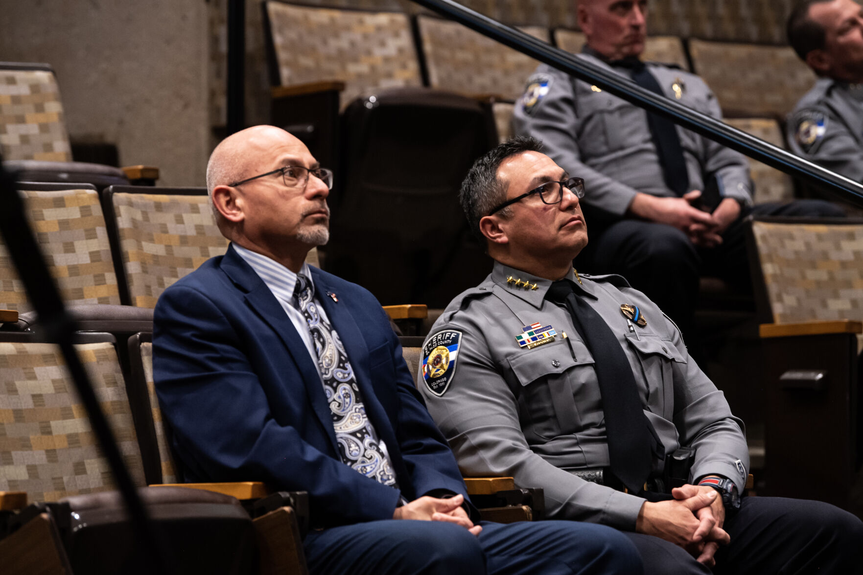 El Paso County Sheriff Joe Roybal, right, and El Paso County District 4 Commissioner Longinos Gonzalez watch footage of a police interaction with Nicole Mallery during a press conference regarding the conflict between the Mallery’s and their neighbor Teresa Clark, all farmers in Yoder, at Centennial Hall on Tuesday, Feb. 14, 2023. (Parker Seibold, The Gazette) (Parker Seibold)