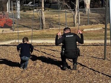 FILE PHOTO: Arapahoe County Sheriff’s Deputy Travis Jones encourages a student having a rough day at Littleton School District’s Peabody Elementary School in Centennial, where Jones serves as a school resource officer. (Denver Gazette file)