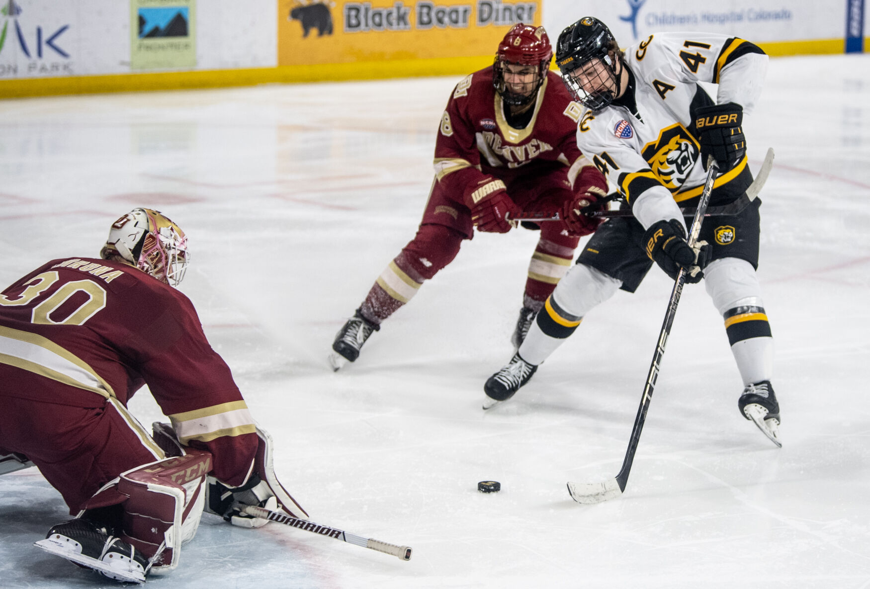 Colorado College forward Ryan Beck (8) hooks Colorado College forward Hunter McKown (41) as he makes a breakaway in the third period of a hockey game on Saturday, Feb. 4, 2023, at Ed Robson Arena in Colorado Springs, Colo. Colorado College forward Hunter McKown (41) was awarded a penalty shot. (Parker Seibold, The Gazette) (Parker Seibold)