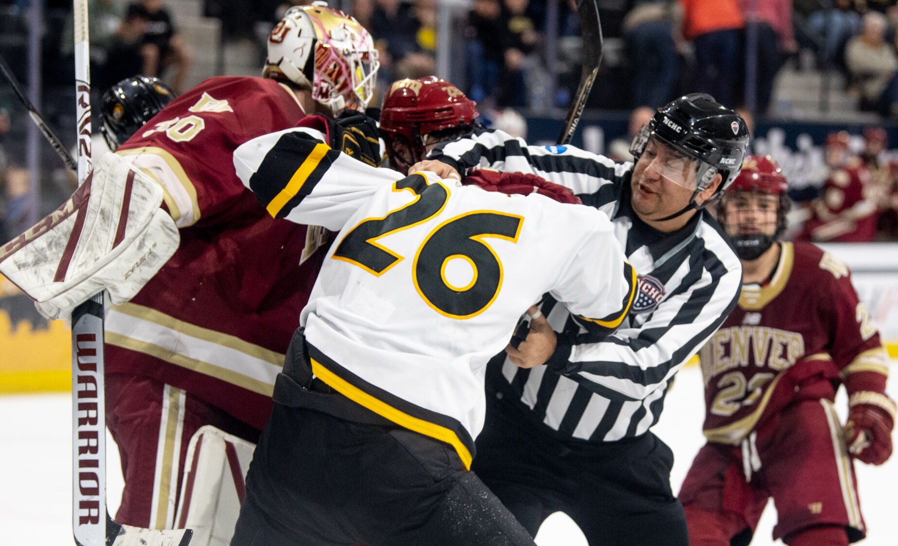 A referee tries to break up a fight in the third period of a hockey game on Saturday, Feb. 4, 2023, at Ed Robson Arena in Colorado Springs, Colo. (Parker Seibold, The Gazette) (Parker Seibold)