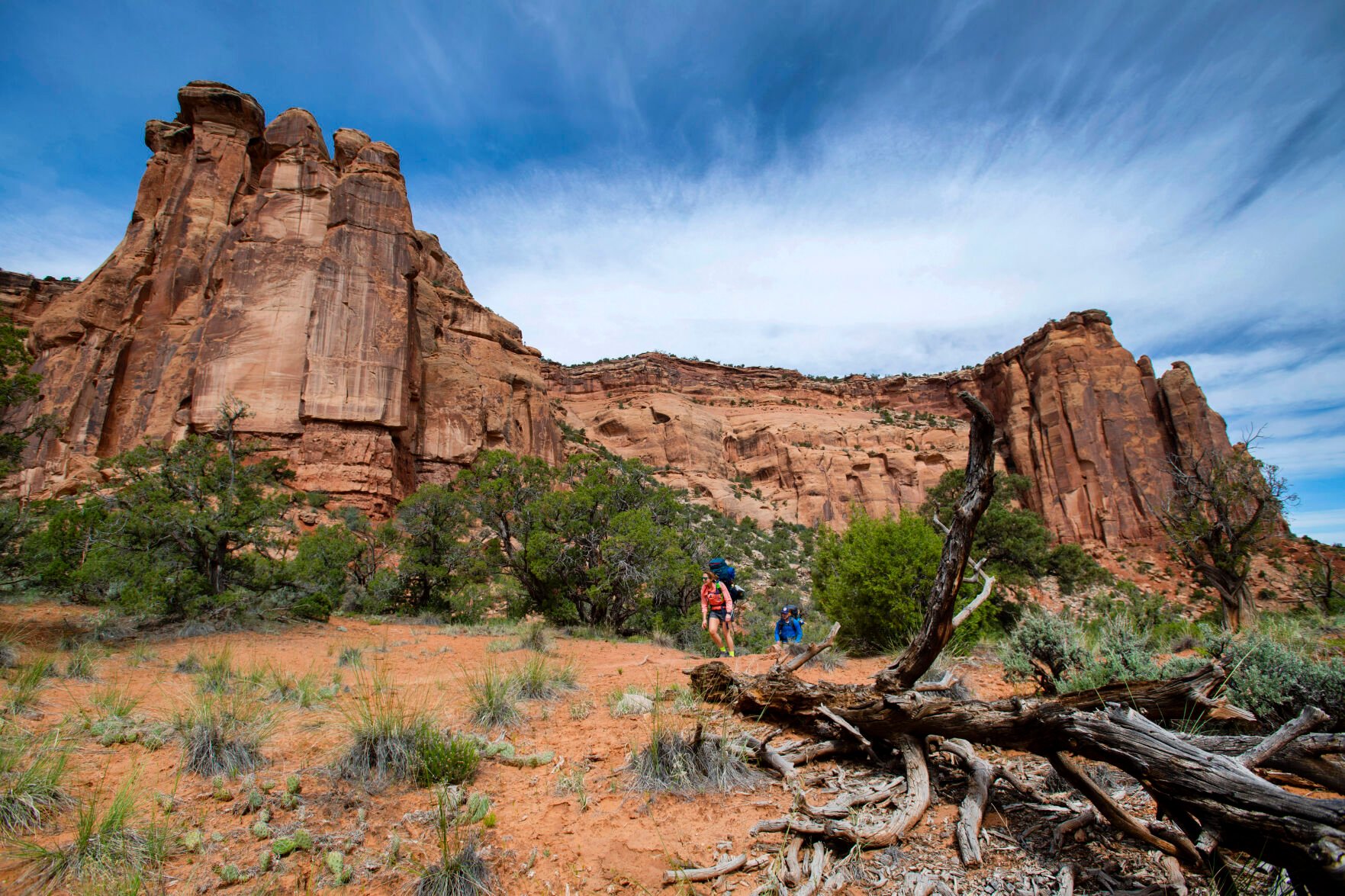 Hannah Grinblatas, left, and Ryan Rilinger of Boston hike Monument Valley Trail last May at Colorado National Monument, outside Fruita. Protecting national monuments and other public lands ranks high in the 2023 Conservation in the West Poll. (the Gazette)