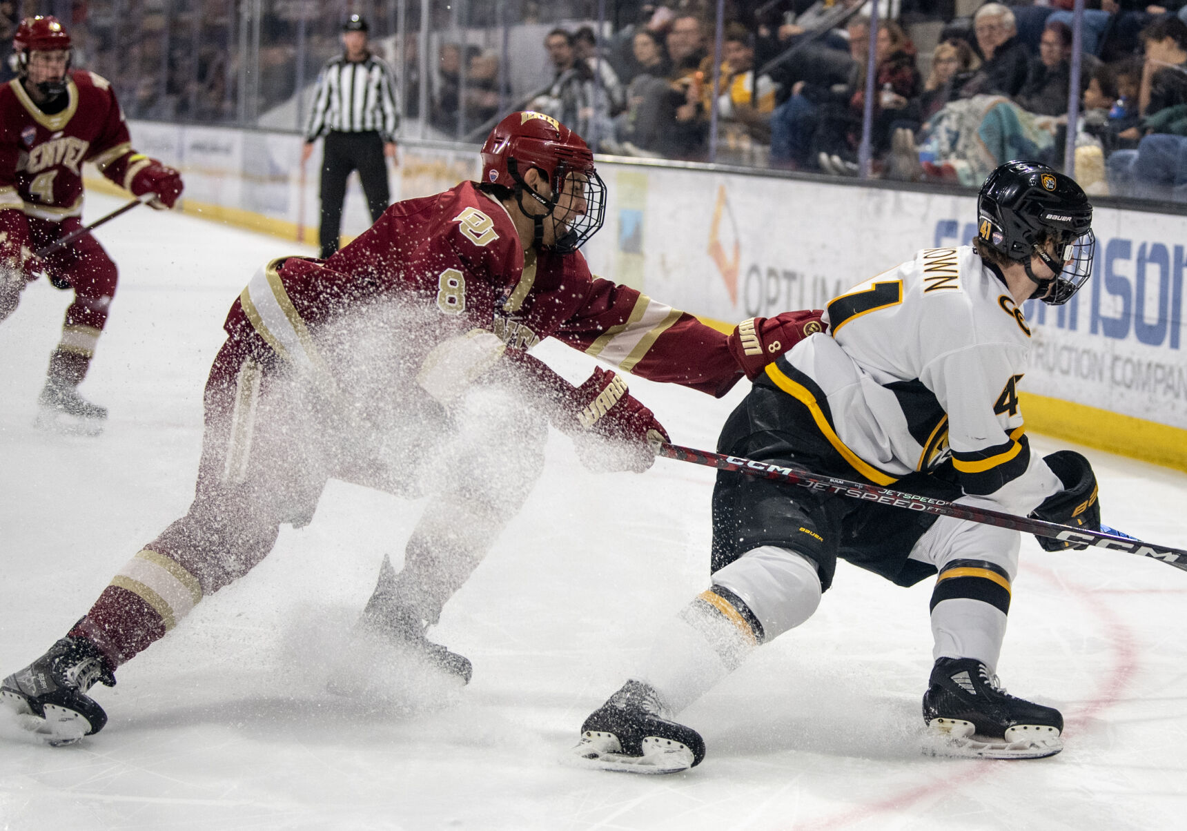 Denver defenseman Shai Buium (8) defends Colorado College forward Hunter McKown (41) as they race toward the puck in the first period of a hockey game on Saturday, Feb. 4, 2023, at Ed Robson Arena in Colorado Springs, Colo. (Parker Seibold, The Gazette) (Parker Seibold)
