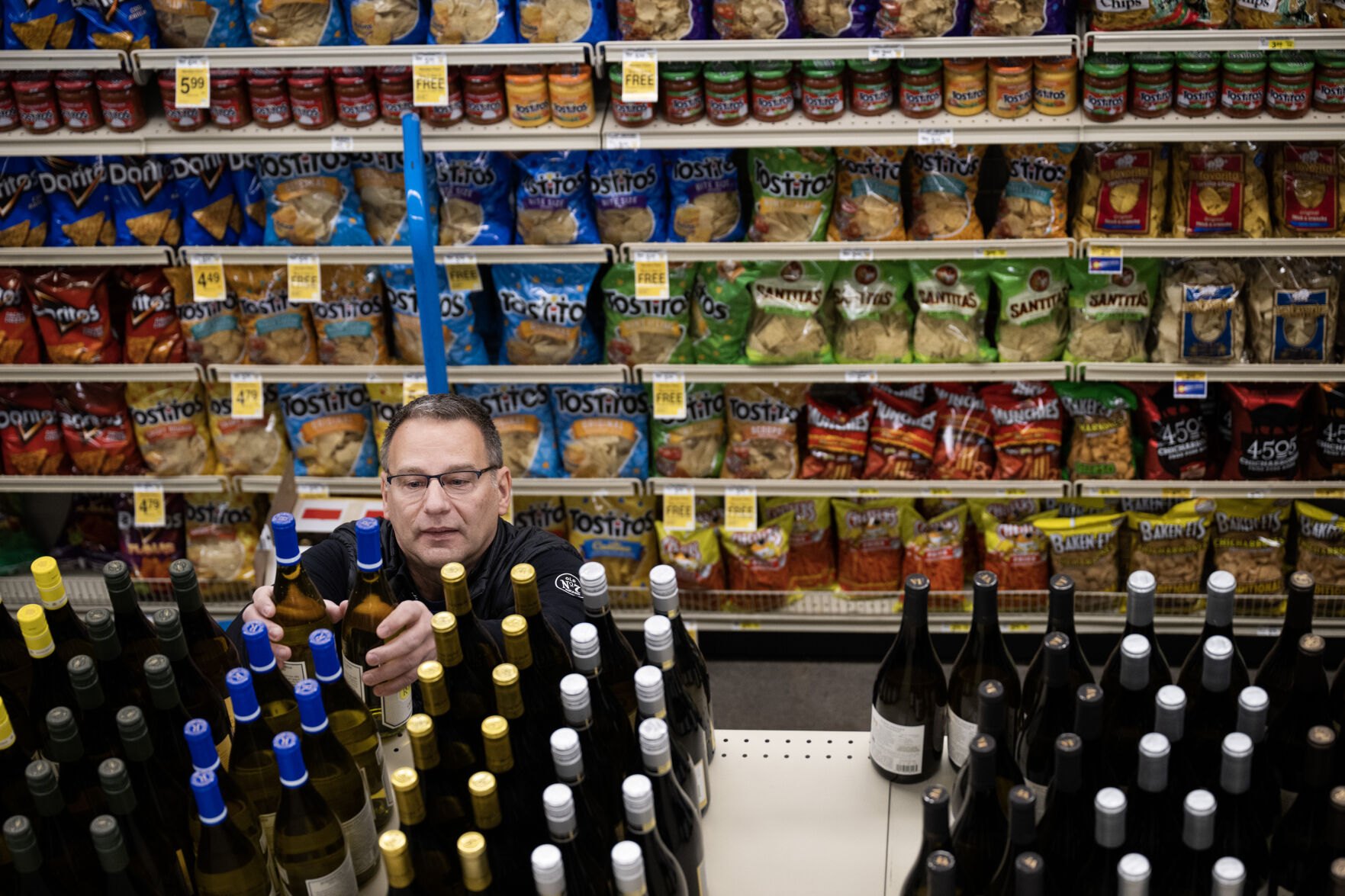 Jim Ruffcorn with the Brown–Forman Distilleries company helps stock aisle three with wine on Wednesday morning, March 1, 2023, at the Safeway grocery store on South Havana Street in Aurora, Colo. (Timothy Hurst/Denver Gazette) (Timothy Hurst/Denver Gazette)