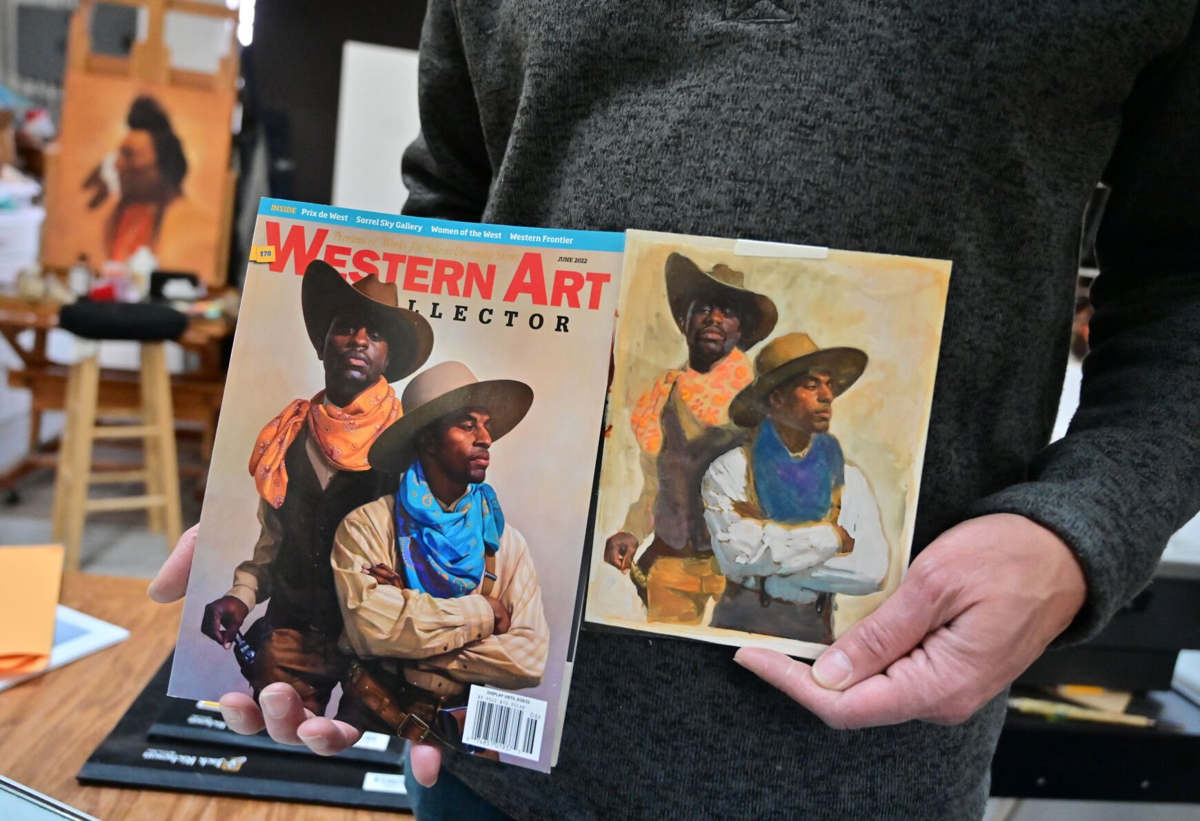 Western Art Collector magazine featured Thomas Blackshear III’s painting of two African American cowboys as their cover art. He shows the magazine and an earlier rendition of the painting.