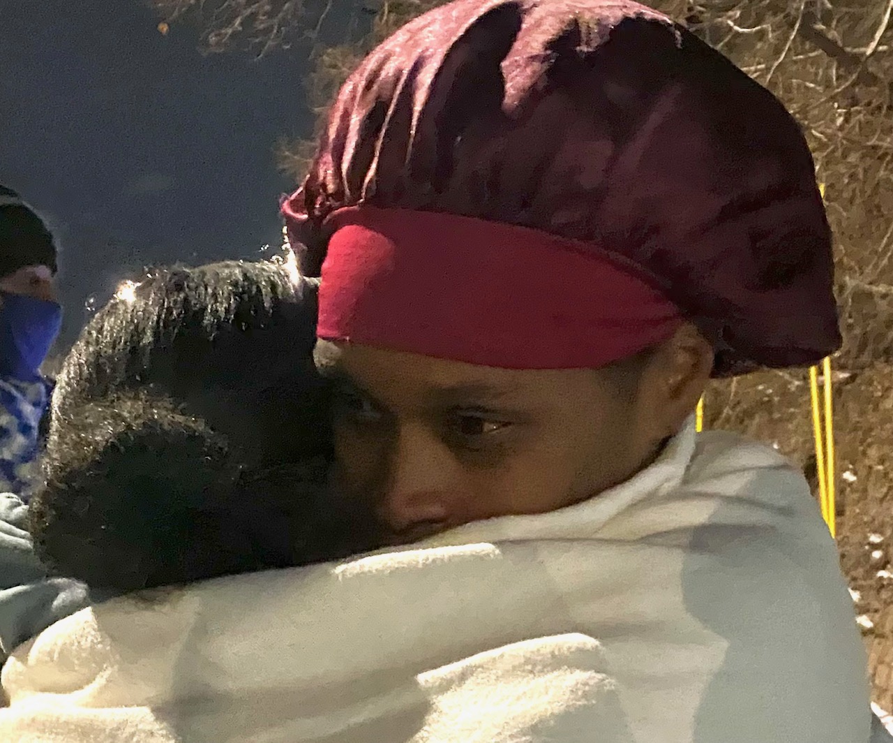 Turquisha Moore-Armstrong hugs Alicia Henderson, Elias Armstrong's sister, at a vigil Thursday night. The Armstrong family was protesting the fact that no charges have been filed against the man who allegedly killed the 12 year old. Denver District Attorney Beth McCann told the family the shooting was justified, said Moore-Armstrong. (Carol McKinley)