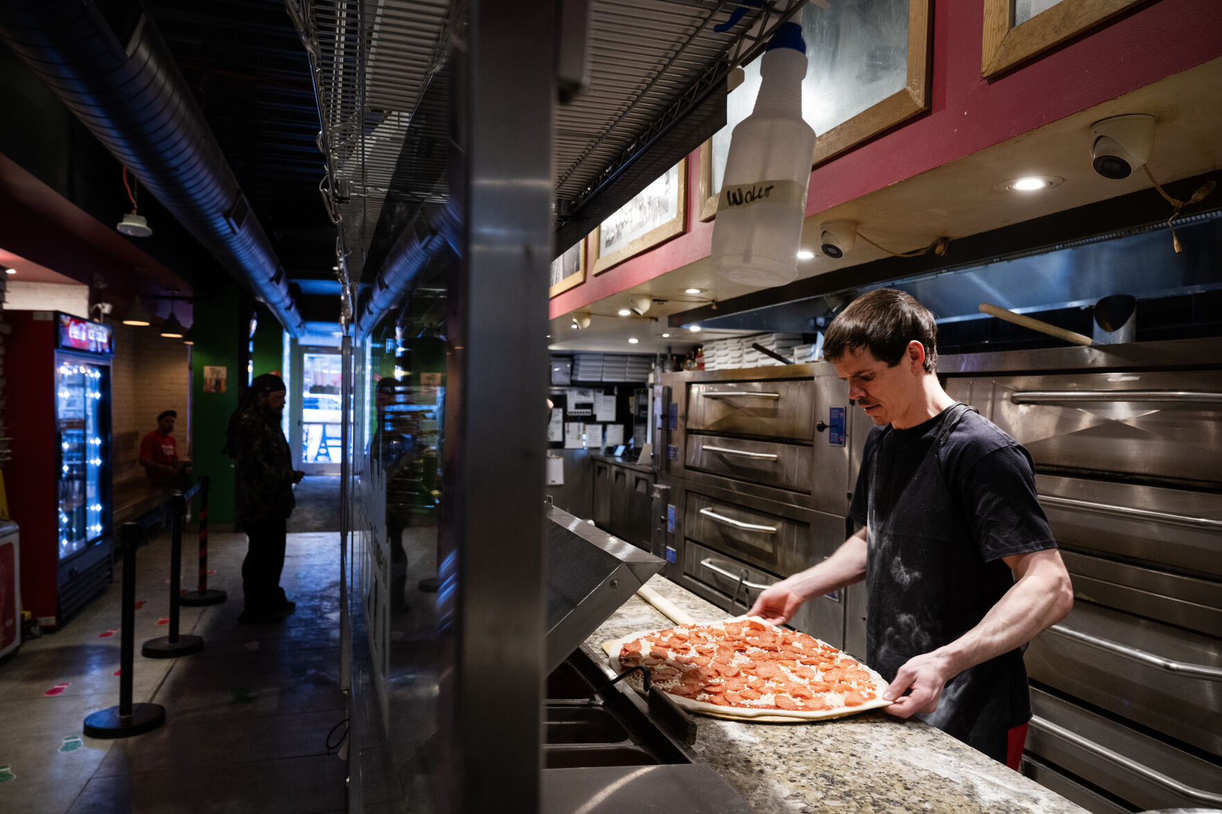 Brooklyn's Finest Pizza kitchen manager Michael Graves works on a customer’s large house pepperoni pizza on Friday, Feb. 17, 2023, in Denver, Colo. (Timothy Hurst/The Denver Gazette) (TIMOTHY HURST/DENVER GAZETTE)