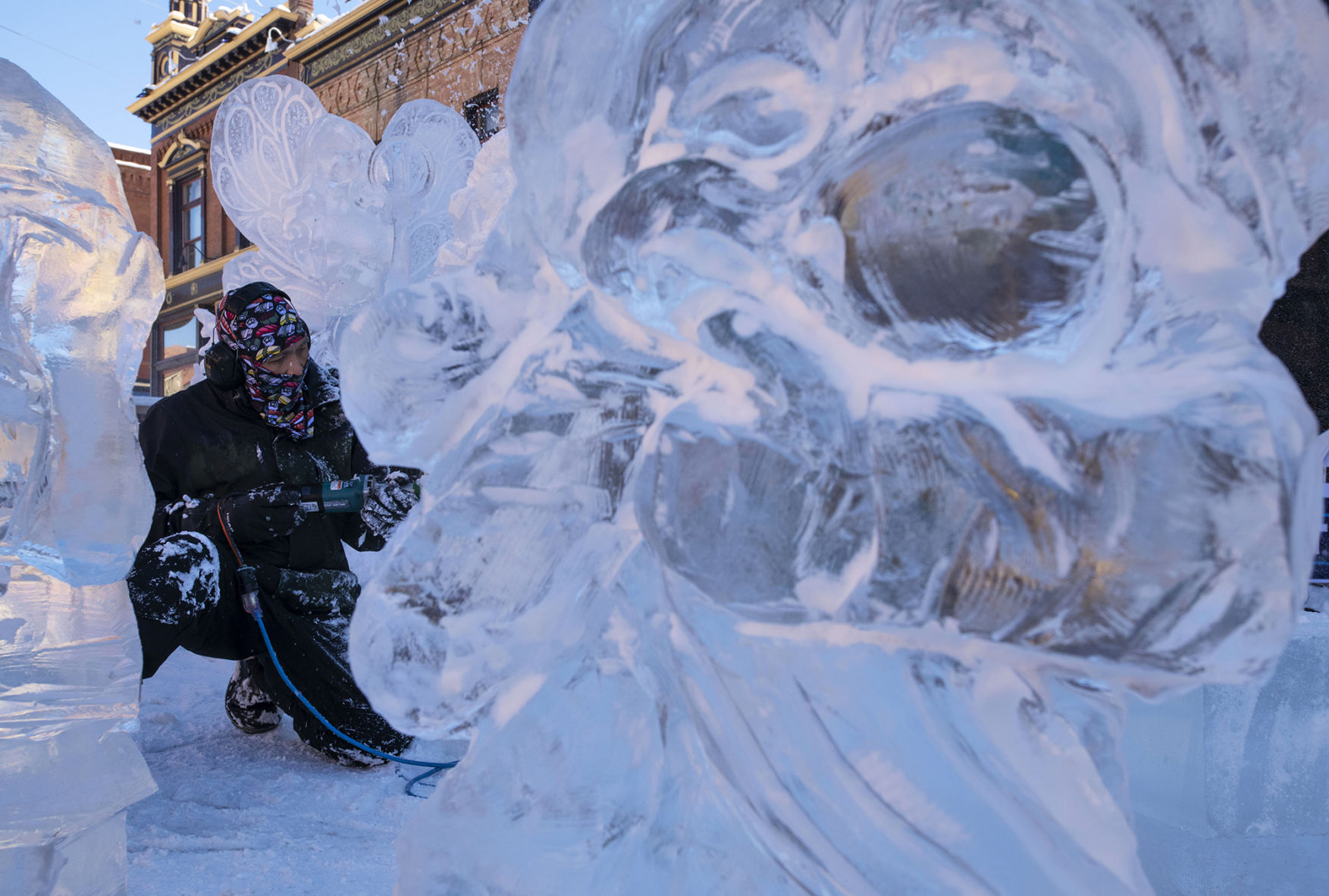 Luan Bui, from Vietnam now a resident of Longmont, works on carving a unicorn with his team Ice Cubed of Denver and their theme of Mystical Creatures during the 13th annual Cripple Creek Ice Festival. (The Gazette file)