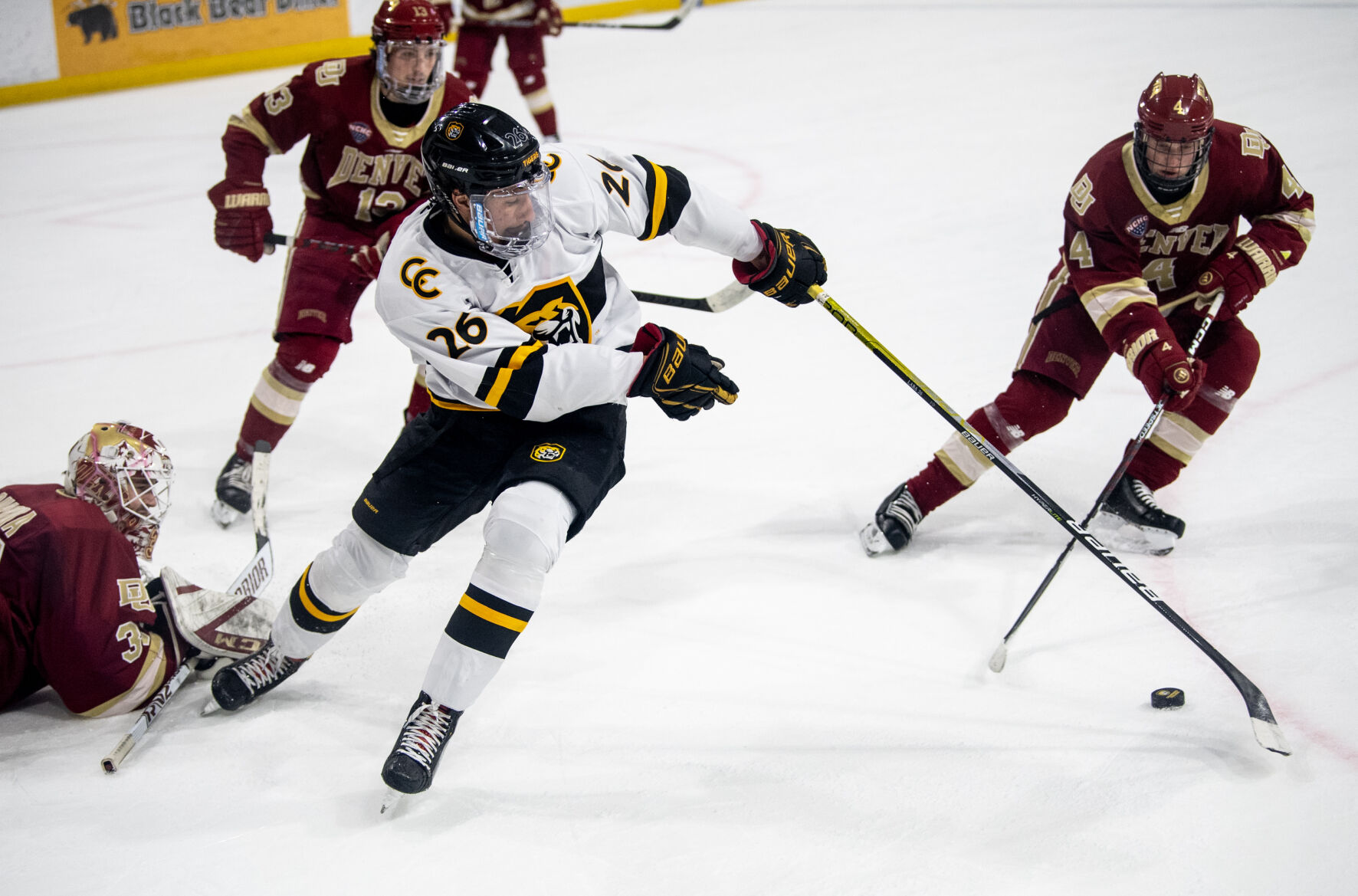 Colorado College forward Noah Laba (26) tries to gain control of the puck near Denver University’s goal in the first period of a hockey game on Saturday, Feb. 4, 2023, at Ed Robson Arena in Colorado Springs, Colo. (Parker Seibold, The Gazette) (Parker Seibold)
