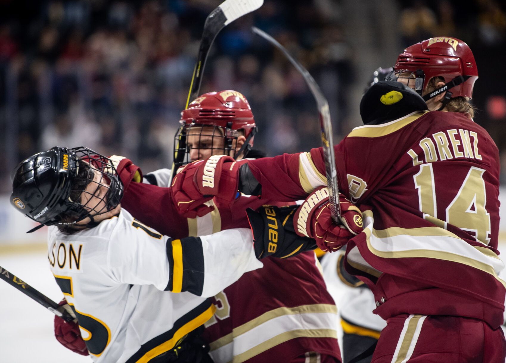 Denver forward Rieger Lorenz (14) punches Colorado College forward Matthew Gleason (15) after an all out brawl had begun between Colorado College and Denver University with less than 30 second left in the third period of a hockey game on Saturday, Feb. 4, 2023, at Ed Robson Arena in Colorado Springs, Colo. (Parker Seibold, The Gazette) (Parker Seibold)