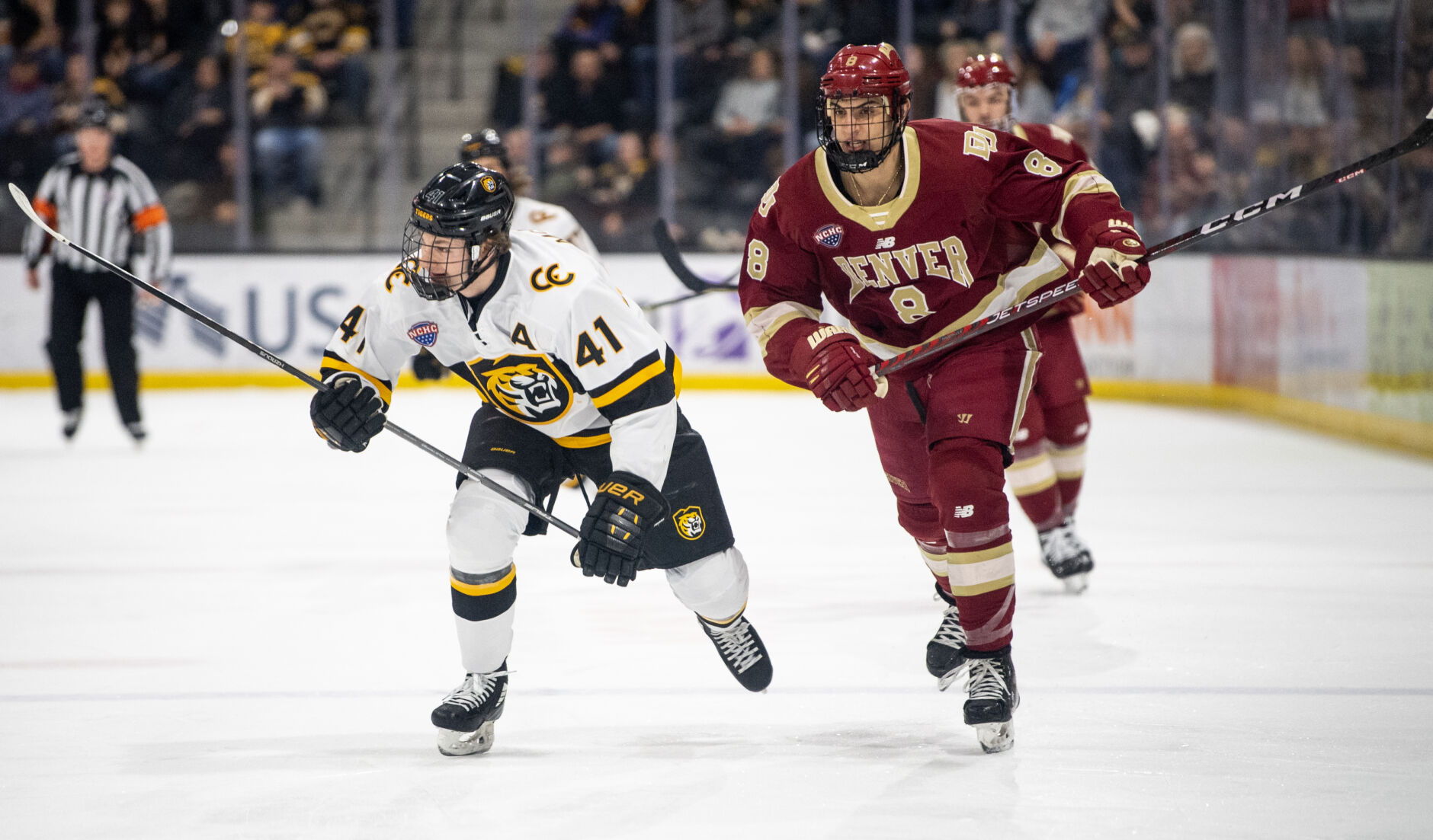 Denver defenseman Shai Buium (8) and Colorado College forward Hunter McKown (41) skate toward the puck in the first period of a hockey game on Saturday, Feb. 4, 2023, at Ed Robson Arena in Colorado Springs, Colo. (Parker Seibold, The Gazette) (Parker Seibold)