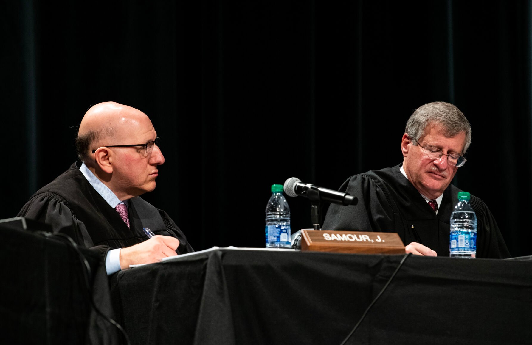 Colorado Supreme Court Justices Carlos A. Samour Jr., left, and Richard L. Gabriel listen to an argument during a Courts in the Community event held at Pine Creek High School in Colorado Springs on Thursday, Nov. 17, 2022. (Parker Seibold, The Gazette)