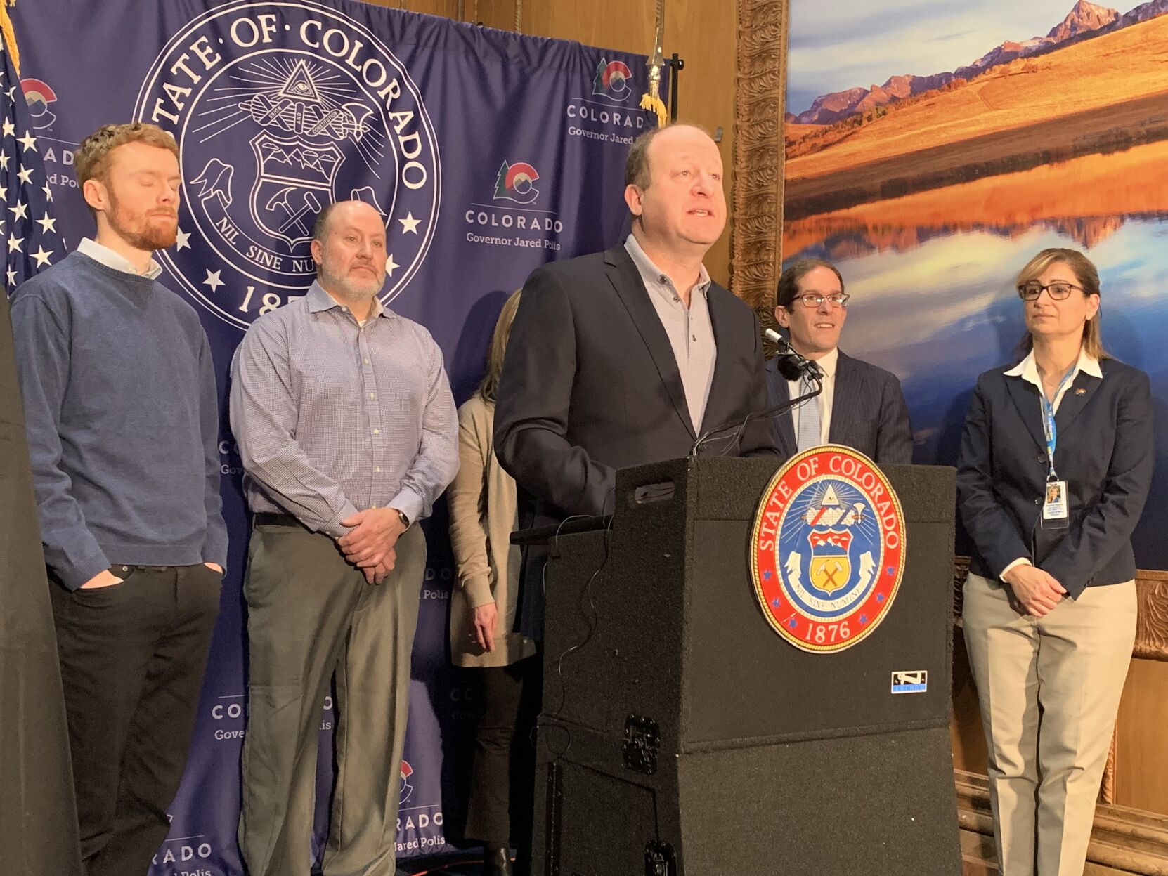 Gov. Jared Polis, joined by Evan Griesheimer (far left), Calista Blaschke and her parents (center) and Department of Revenue Executive Director Mark Ferrandino, in announcing the winners of the contest to create the design for the state's 150th birthday. (MarianneGoodlandmarianne.goodland@coloradopolitics.comhttps://secure.gravatar.com/avatar/125a14b7bd9266f61a445ec13b1d3605?d=mm&r=g)
