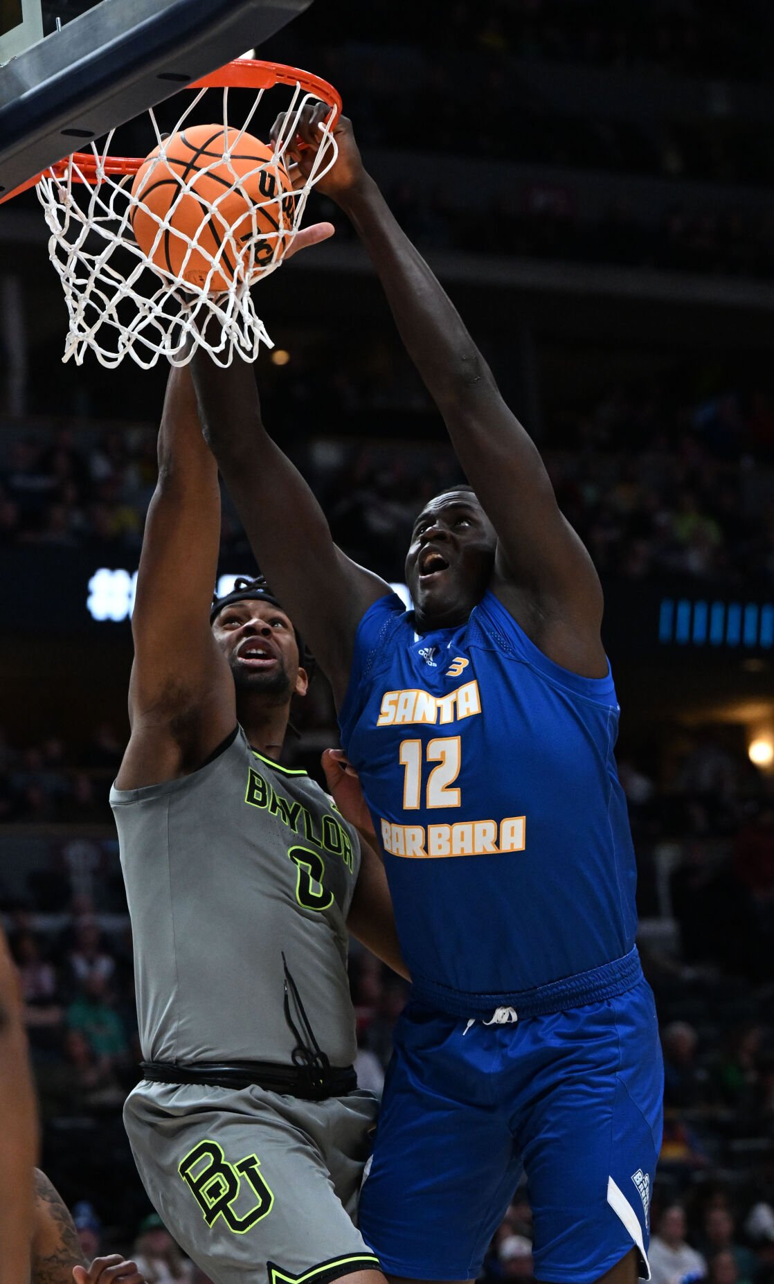 UC Santa Barbara Gauchos forward Evans Kipruto (12) dunks the ball over Baylor Bears forward Flo Thamba (0) during the first half of a first round of the Men’s NCAA Tournament Friday, March 17, 2023, at Ball Arena in Denver. (The Gazette, Christian Murdock) (Christian Murdock/The Gazette)