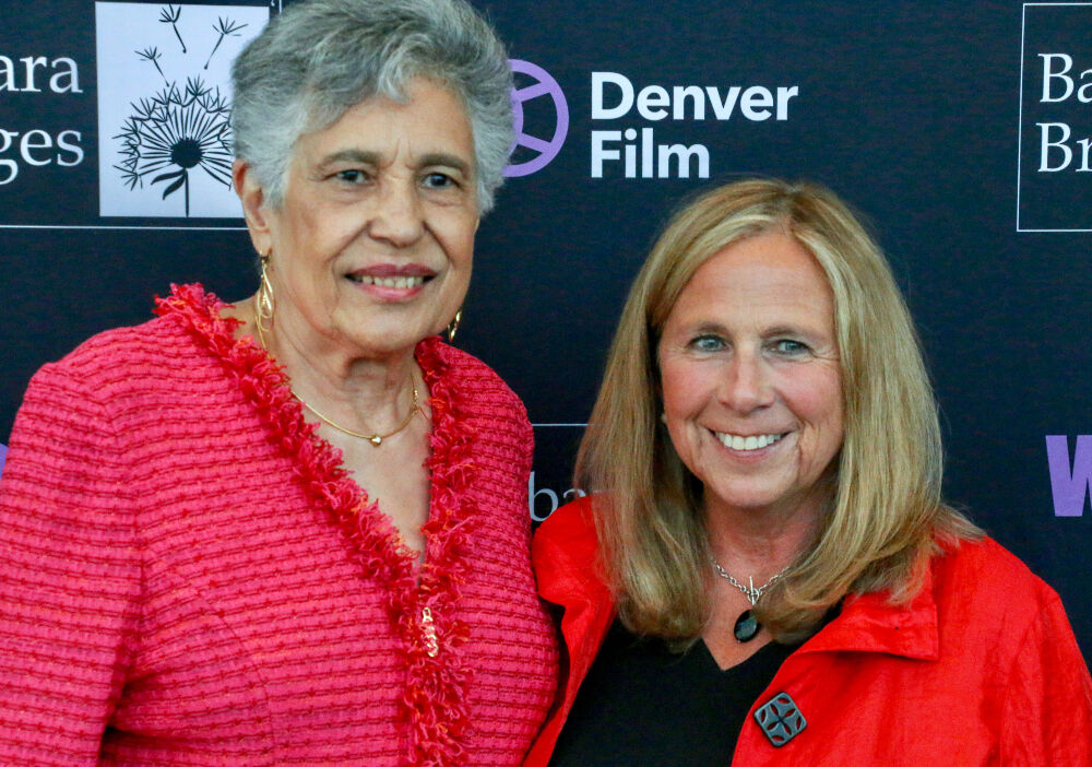 Carlotta Walls LaNier, left, received the Women + Film Impact Award at a 2022 luncheon from retiring festival founder Barbara Bridges. Walls LaNier made history as the youngest member of the Little Rock Nine. Bridges has announced her resignation 14 years after founding the film festival. (Photo by John Moore, The Denver Gazette)