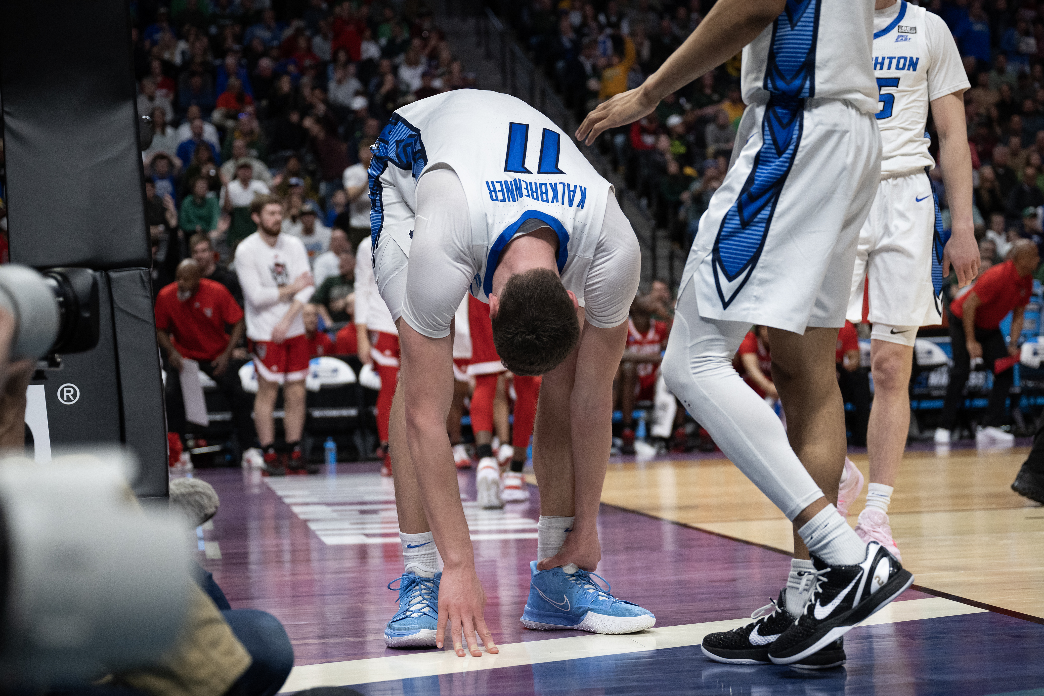 Creighton Bluejays center Ryan Kalkbrenner (11) grabs his ankle after attempting to block a North Carolina State player during a first-round college basketball game in the NCAA Tournament on Friday, March 17, 2023, at Ball Arena in Denver, Colo. (Timothy Hurst/Denver Gazette) (TimHursttim.hurst@gazette.comhttps://secure.gravatar.com/avatar/aca82bd62b4ee425c598527cd6faa1b1?d=mm&r=g)