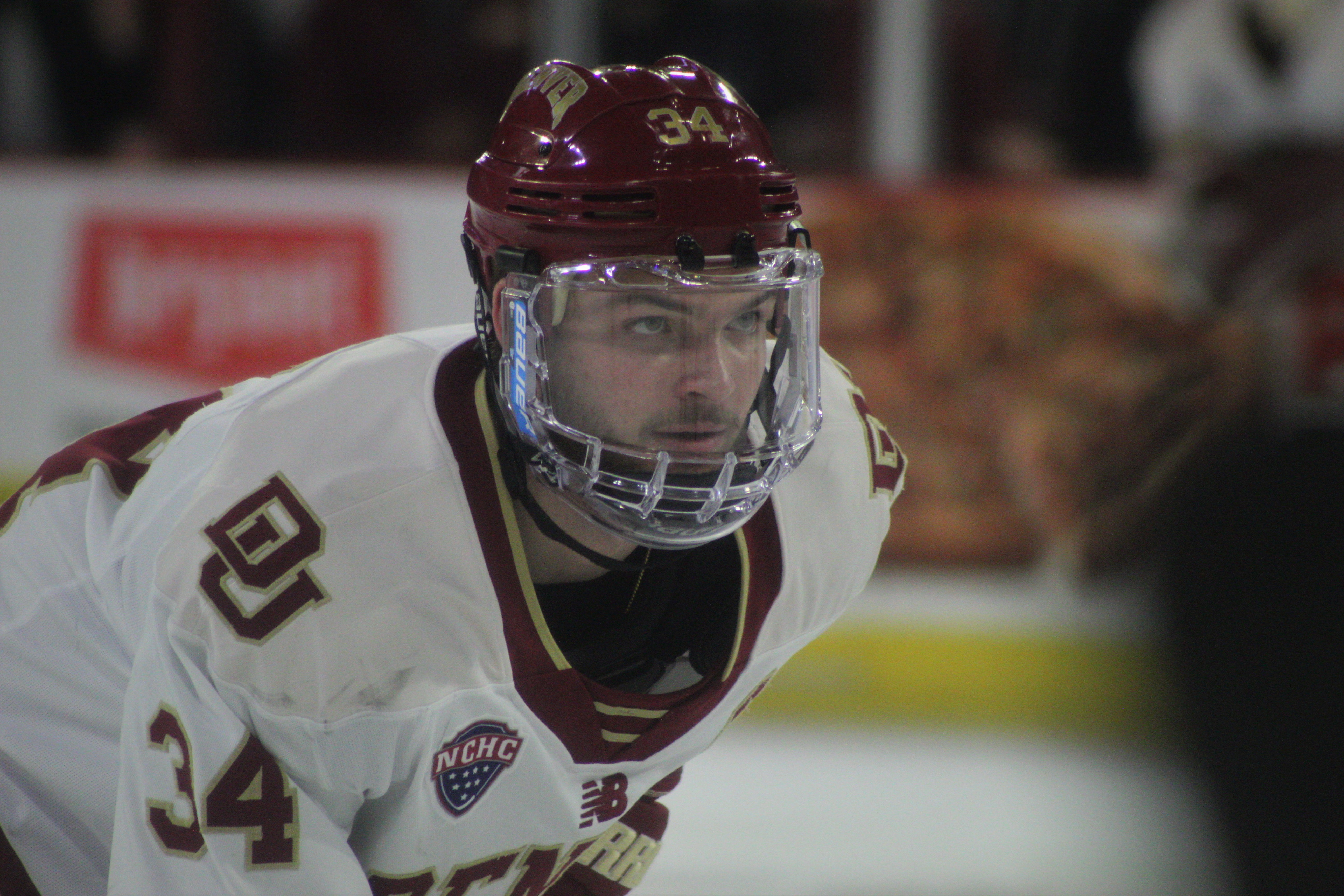 Denver sophomore forward Carter Mazur (34) waits for a faceoff during the second period of a game against North Dakota on Saturday, Feb. 11, 2023 at Magness Arena in Denver. (Tyler King, The Denver Gazette)