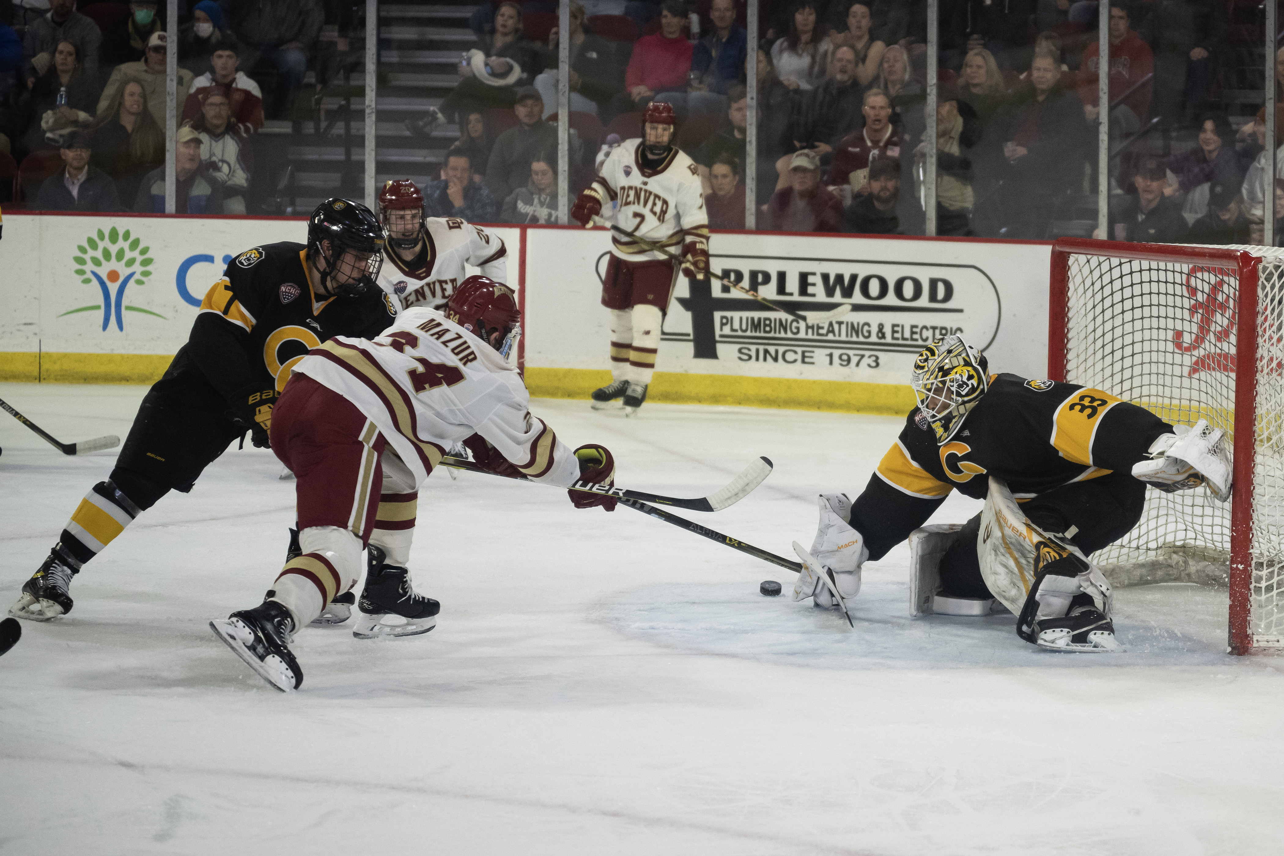 Colorado College freshman goalie Kaidan Mbereko (33) saves a shot by University of Denver sophomore forward Carter Mazur (34) in the second period on Friday, March 3, 2023, at Magness Arena in Denver, Colo. (Timothy Hurst/Denver Gazette) (TimHursttim.hurst@gazette.comhttps://secure.gravatar.com/avatar/aca82bd62b4ee425c598527cd6faa1b1?d=mm&r=g)