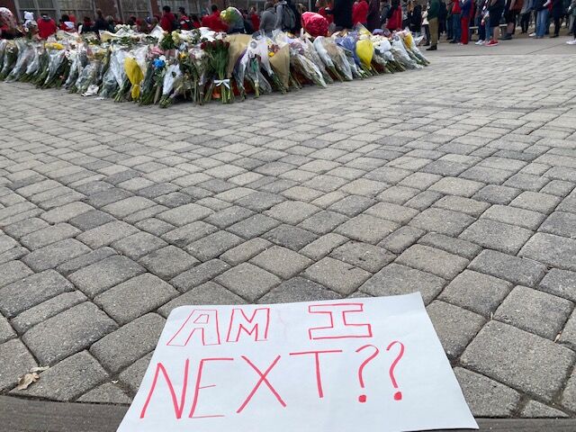 Over 1,000 students, parents, religious leaders and politicians marched to the state capitol Friday to advocate for stricter gun laws in Colorado. Some carried signs with blunt messages, like this one, laid out in front of a shrine to slain East High student Luis Garcia. (Carol McKinley/Denver Gazette)