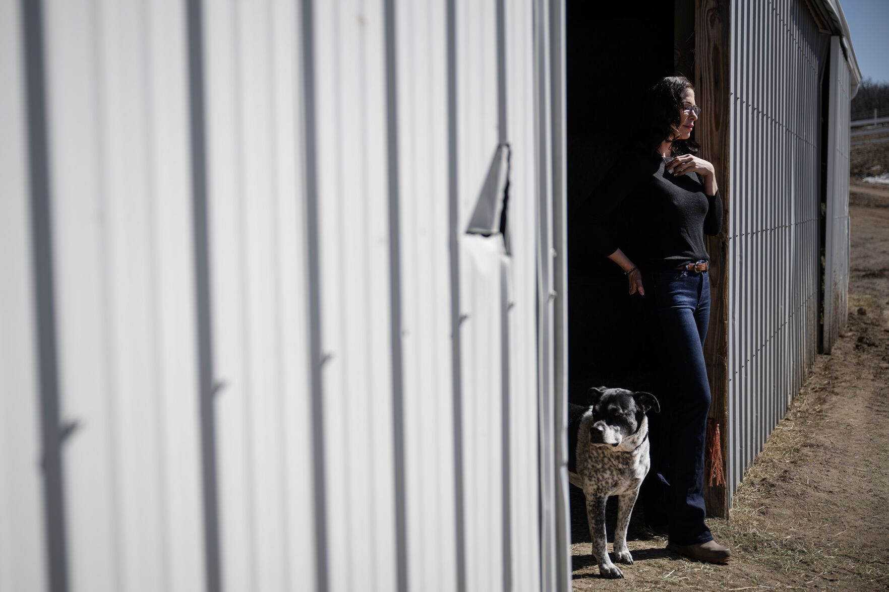 Lauren May Woodruff stands for a portrait outside a horse barn with her 10-year-old rescue farm dog, Chance, on Thursday, March 2, 2023, at her property in Douglas County, Colo. (Timothy Hurst/Denver Gazette) (TimHursttim.hurst@gazette.comhttps://secure.gravatar.com/avatar/aca82bd62b4ee425c598527cd6faa1b1?d=mm&r=g)