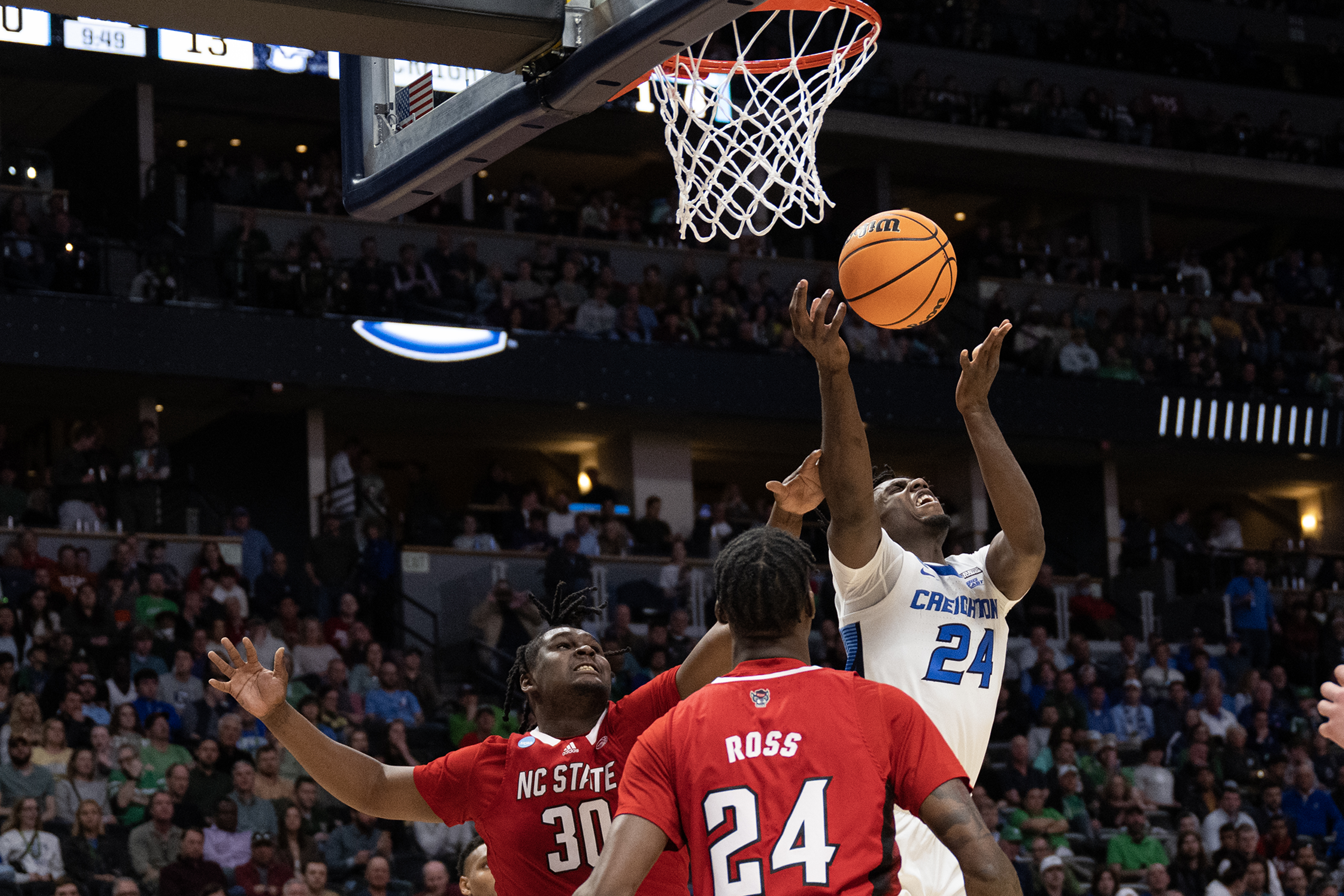 Creighton sophomore forward Arthur Kaluma (24) attempts a shot over North Carolina State forward DJ Burns Jr. (30 during a first-round college basketball game in the NCAA Tournament on Friday, March 17, 2023, at Ball Arena in Denver, Colo. (Timothy Hurst/Denver Gazette) (Timothy Hurst/Denver Gazette)