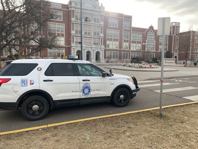 As the march left the East High school perimeter Friday, some Denver police cars stayed behind to keep watch on the campus area. (Carol McKInley)