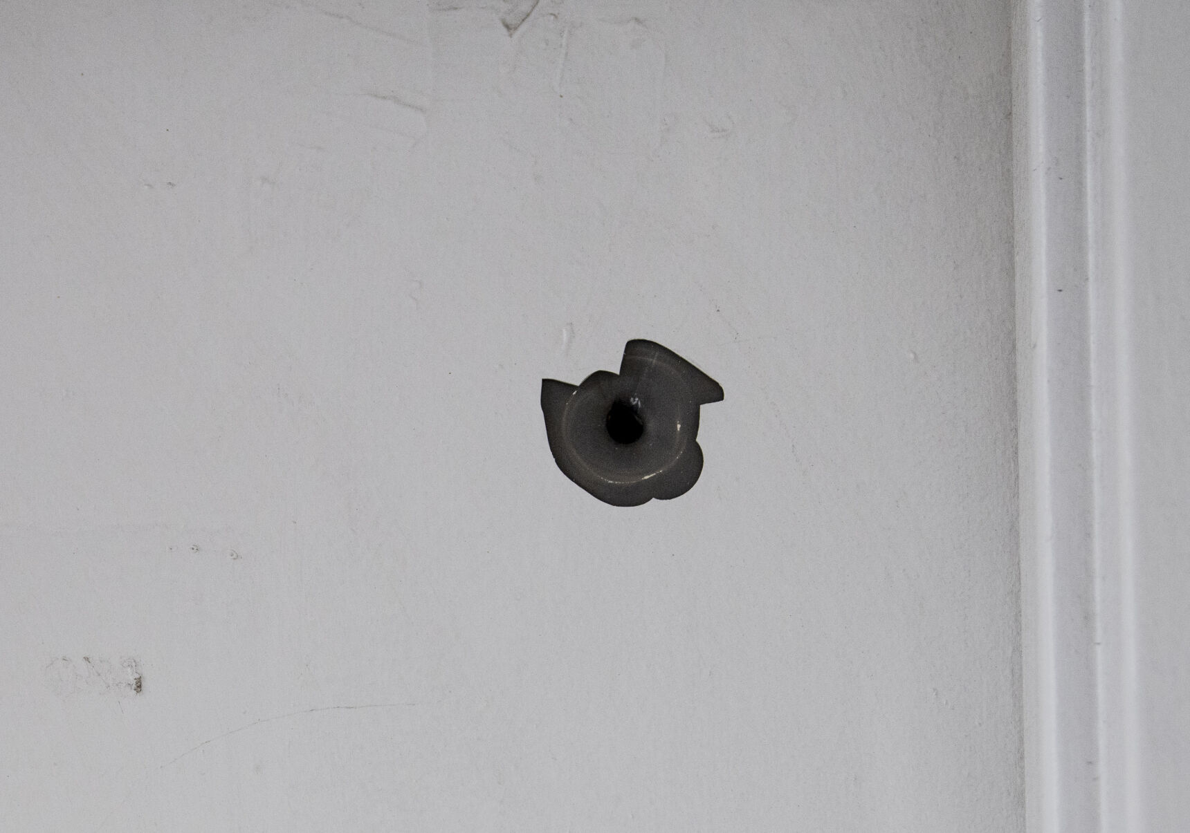 A bullet hole from a recent shoot can be seen in the bathroom door at the Alta Convenience store next door to Babilonia. (Parker Seibold / The Gazette) (Parker Seibold / The Gazette)