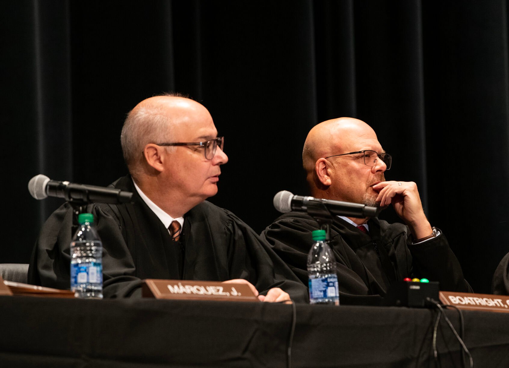 Colorado Supreme Court Chief Justice Brian D. Boatright, left, and Justice William W. Hood III, listen to an argument during a Courts in the Community session held at Pine Creek High School in Colorado Springs on Thursday, Nov. 17, 2022. (The Gazette, Parker Seibold) (Parker Seibold)