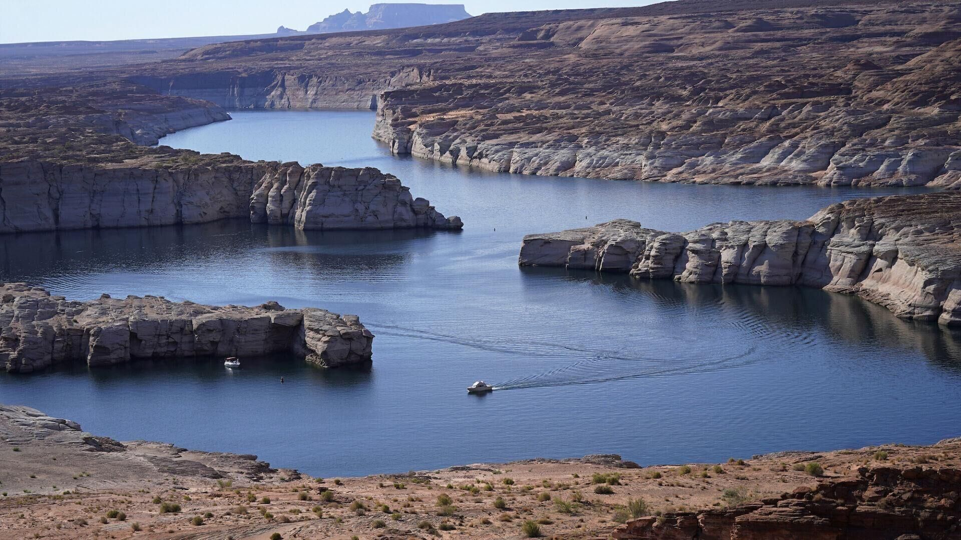 A boat cruises on Lake Powell last year near Page, Ariz. Water levels have been plummeting in Lake Powell and other reservoirs along the lower Colorado River. (Gazette file)