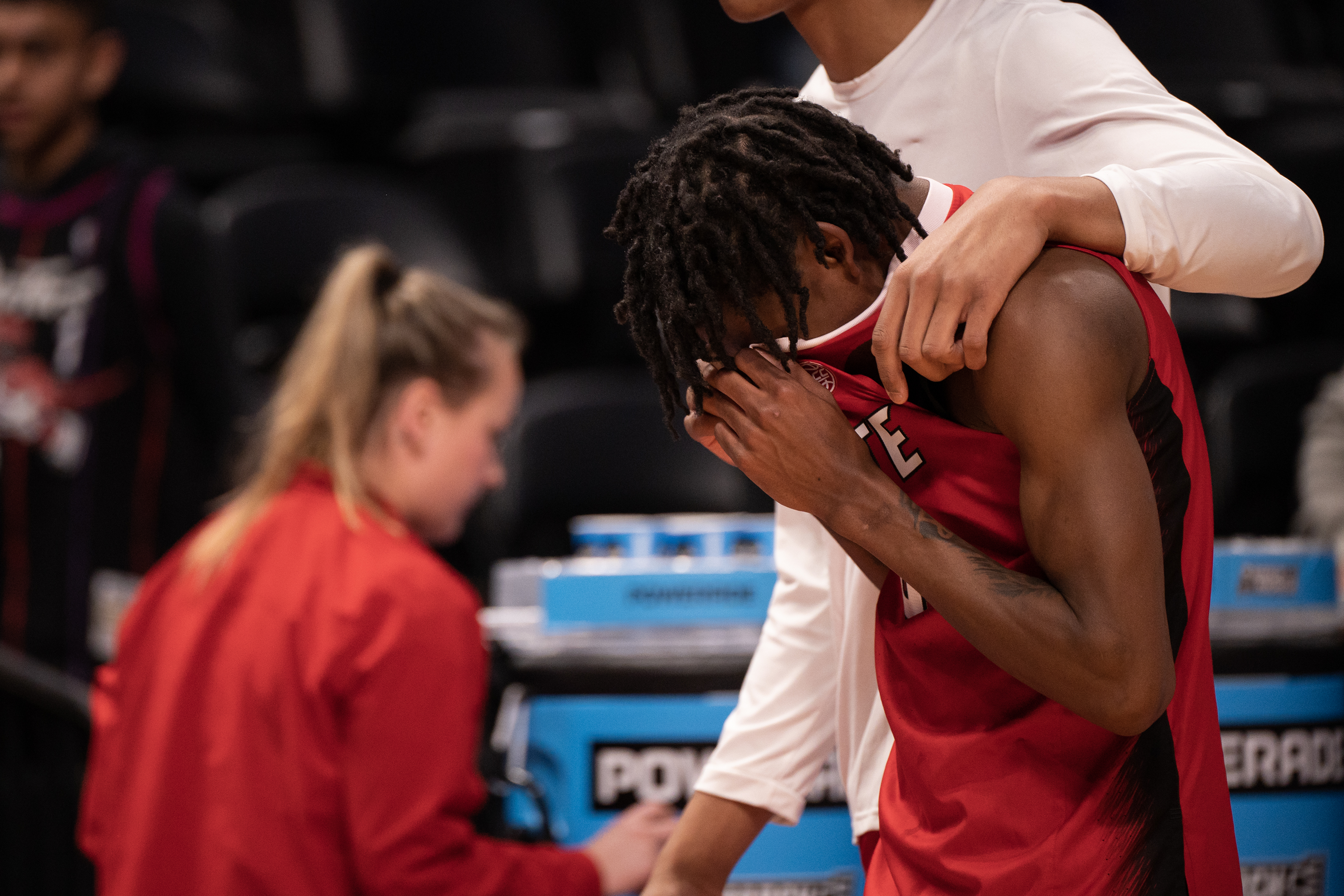 North Carolina State Wolfpack guard Terquavion Smith (0) is comforted by a teammate after a loss to Creighton during a first-round college basketball game in the NCAA Tournament on Friday, March 17, 2023, at Ball Arena in Denver, Colo. (Timothy Hurst/Denver Gazette) (TimHursttim.hurst@gazette.comhttps://secure.gravatar.com/avatar/aca82bd62b4ee425c598527cd6faa1b1?d=mm&r=g)