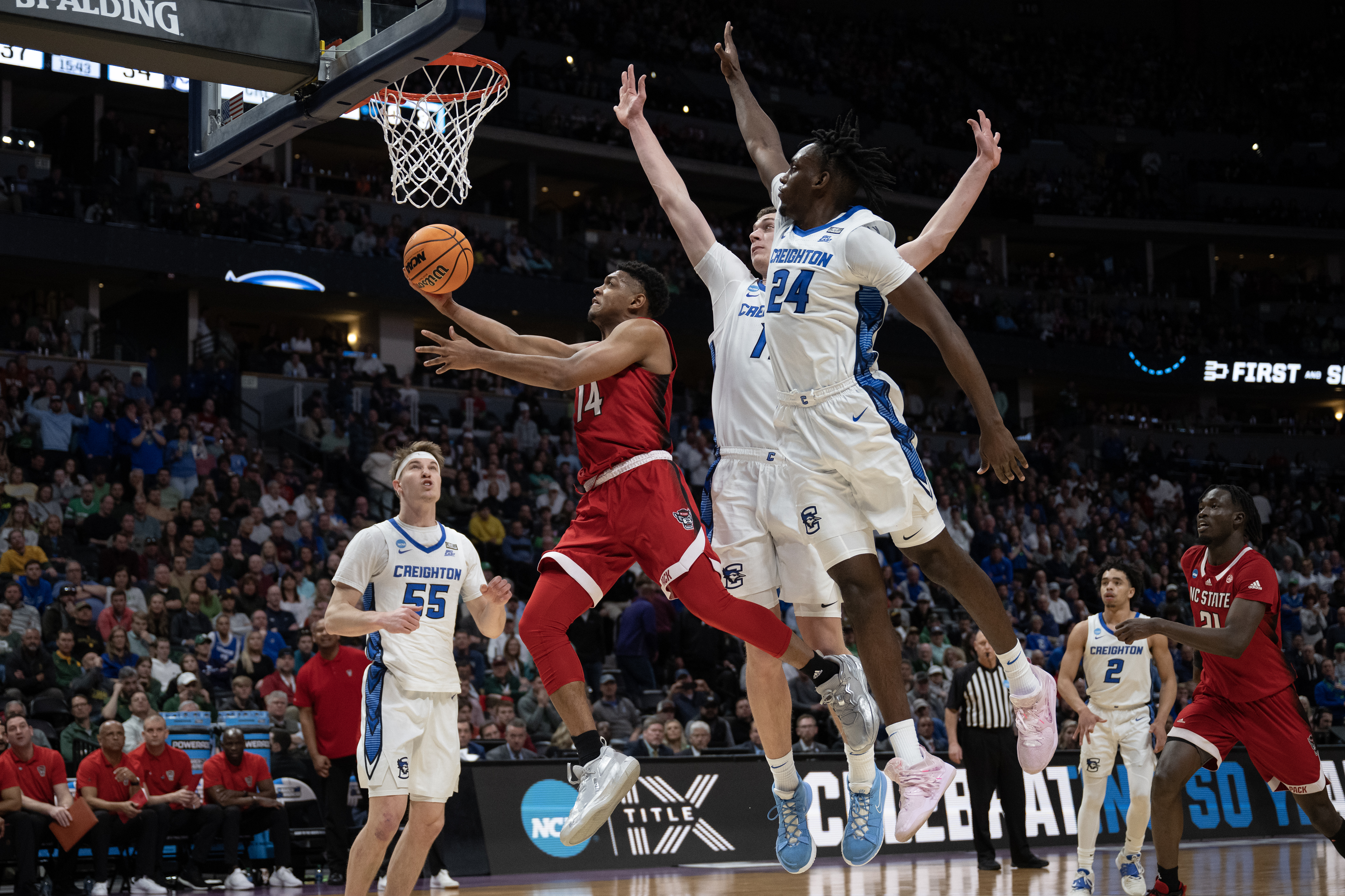 North Carolina State Wolfpack guard Casey Morsell (14) gets a layup past Creighton Bluejays forward Arthur Kaluma (24) and center Ryan Kalkbrenner (11) during a first-round college basketball game in the NCAA Tournament on Friday, March 17, 2023, at Ball Arena in Denver, Colo. (Timothy Hurst/Denver Gazette) (TimHursttim.hurst@gazette.comhttps://secure.gravatar.com/avatar/aca82bd62b4ee425c598527cd6faa1b1?d=mm&r=g)