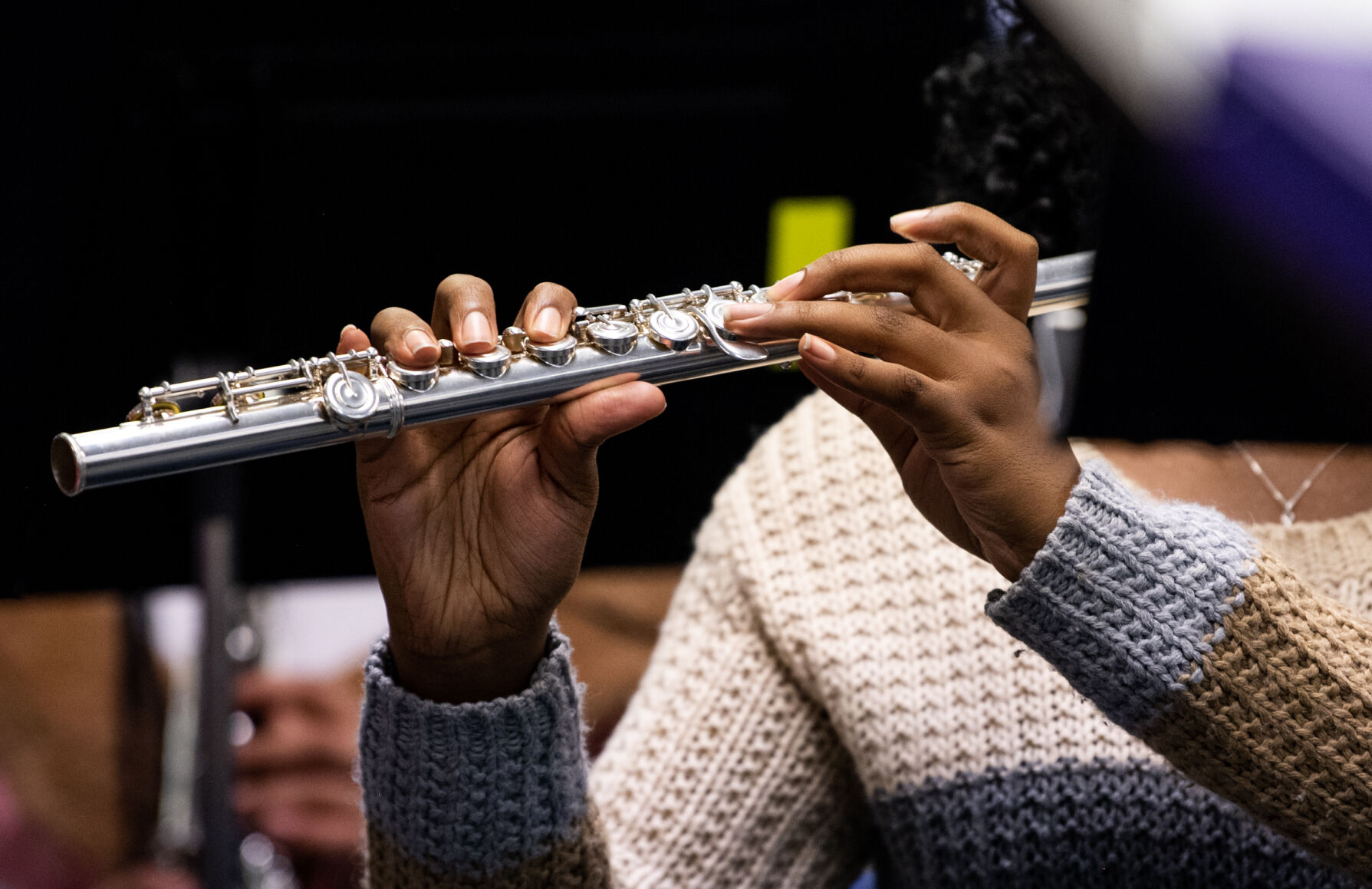 A student at Horizon Middle School plays the flute during band practice. Band teacher Melanie Hawthorne Long said she didn’t want money to keep students from being in band and Bringing Music to Life, a donation program, “makes me be able to say, ‘If your family can’t afford an instrument, I’m going to get you one,’” she says. (Parker Seibold)