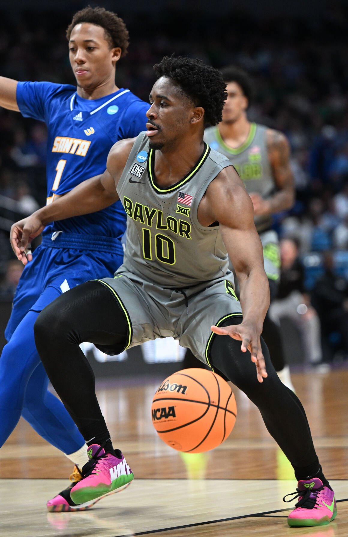 Baylor Bears guard Adam Flagler (10) drives toward the basket as UC Santa Barbara Gauchos guard Josh Pierre-Louis (1) defends during the second half of a first round of the Men’s NCAA Tournament Friday, March 17, 2023, at Ball Arena in Denver. Baylor defeated UC Santa Barbara 74-56. (The Gazette, Christian Murdock) (Christian Murdock/The Gazette)
