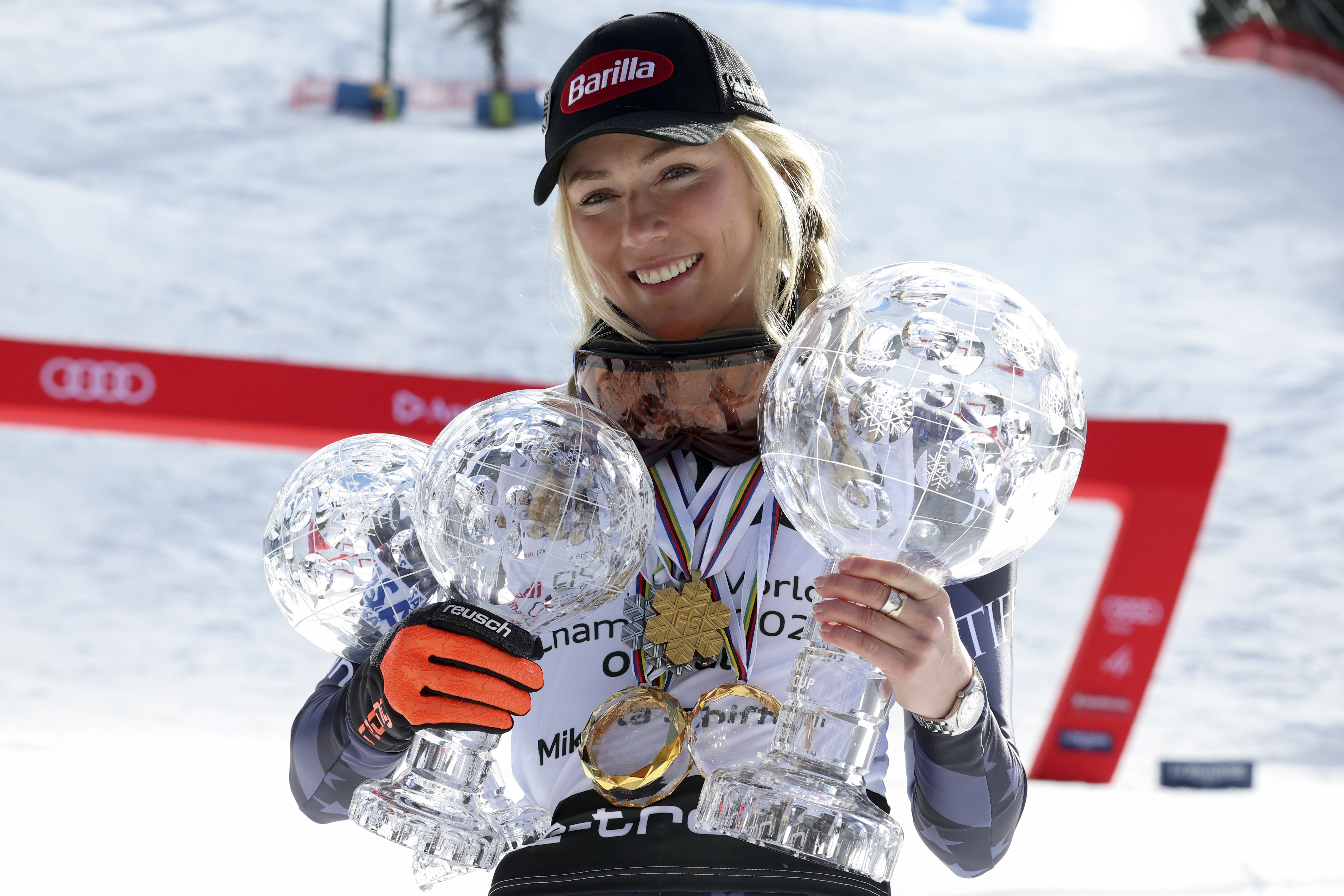 United States' Mikaela Shiffrin poses with her trophies for the alpine ski, World Cup slalom discipline, giant slalom discipline, and overall leader, right, in Soldeu, Andorra, Sunday, March 19, 2023. (Alessandro Trovati - stringer, AP)