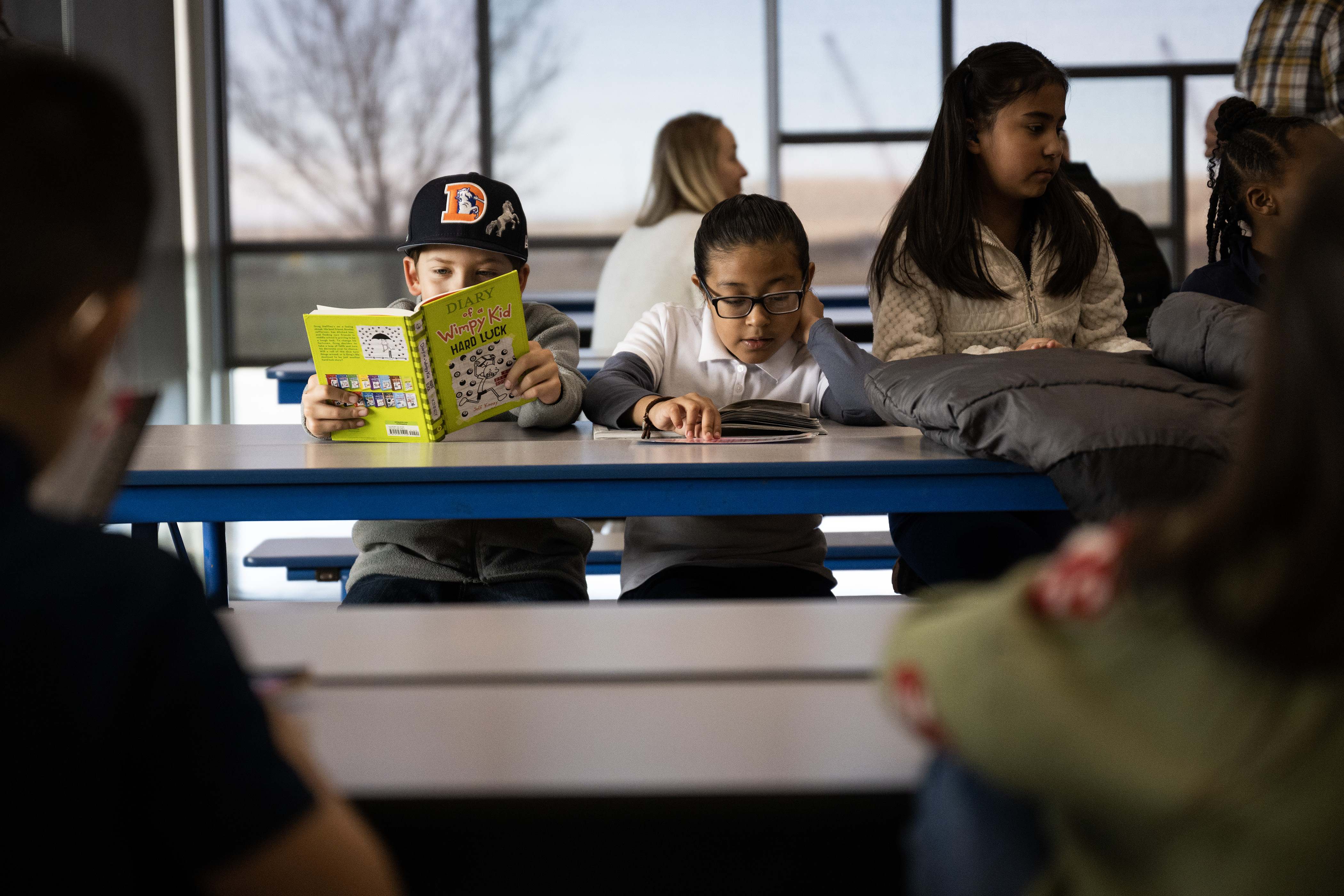 Third grader Aston Topliss, left, reads the copy of “Diary of a Wimpy Kid: Hard Luck” he checked out from Aurora Public Library’s Bookmobile on Tuesday, Feb. 28, 2023, at High Point Academy in Aurora, Colo. (Timothy Hurst/Denver Gazette) (Timothy Hurst/Denver Gazette)