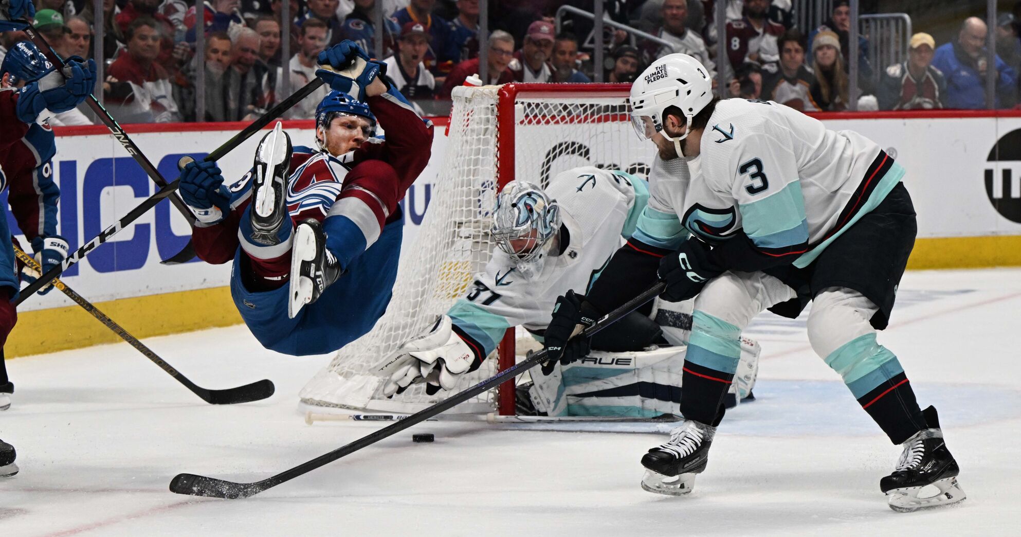 Colorado Avalanche center Nathan MacKinnon (29) falls to the ice as Seattle Kraken goaltender Philipp Grubauer (31) makes a save during the first period of Game 7 of the first round of the Stanley Cup Playoffs Sunday, April 30, 2023, at Ball Arena in Denver. (The Gazette, Christian Murdock) (Christian Murdock/The Gazette)