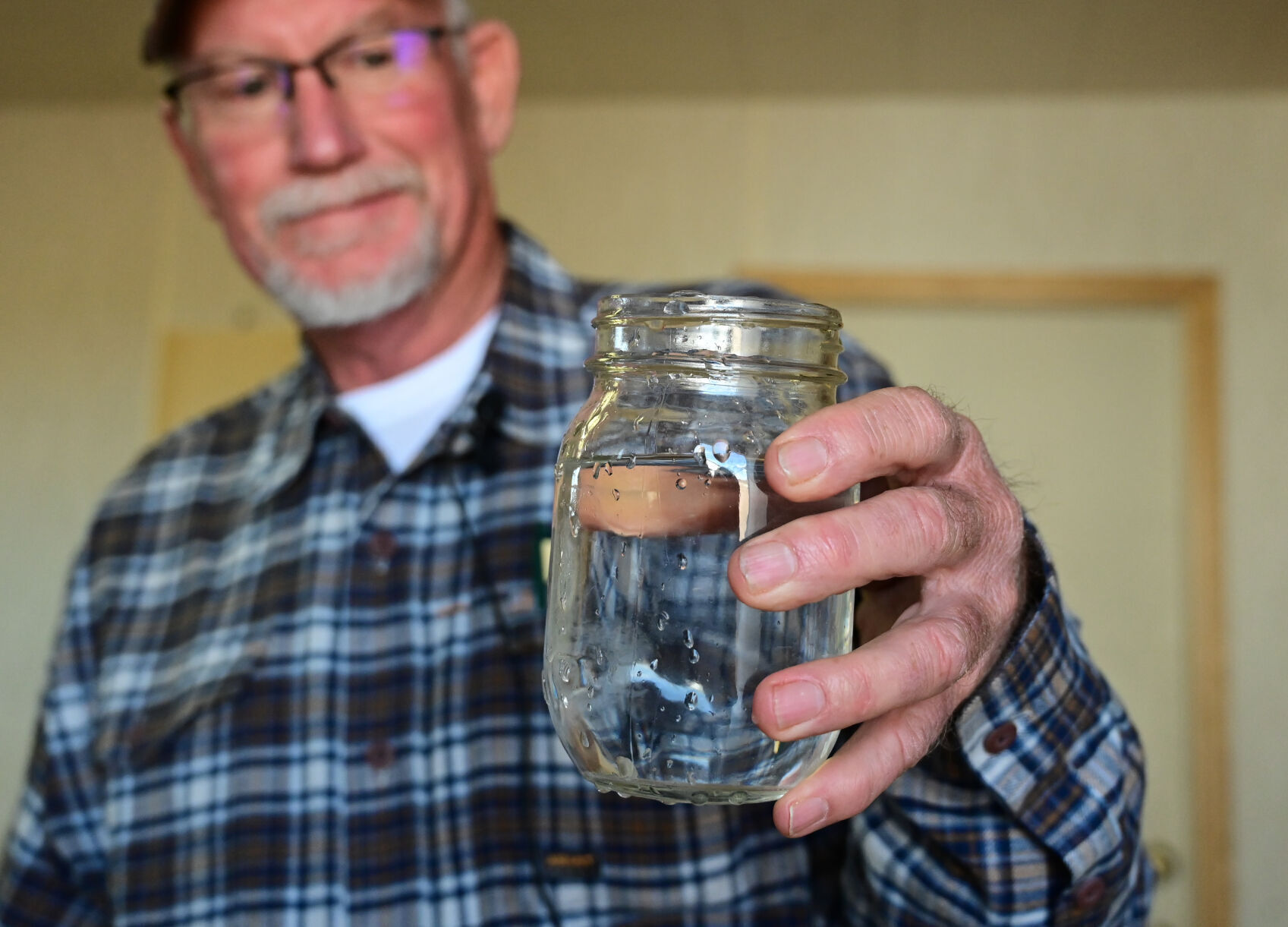 Norman Noe holds up a jar of water from the tap of the South Swink Water Co. near La Junta. Recent data shows some of the highest concentrations of radium in the nation are clustered in rural southeast Colorado. Photo by Jerilee Bennett, the gazette (photos by Jerilee Bennett, the gazette)
